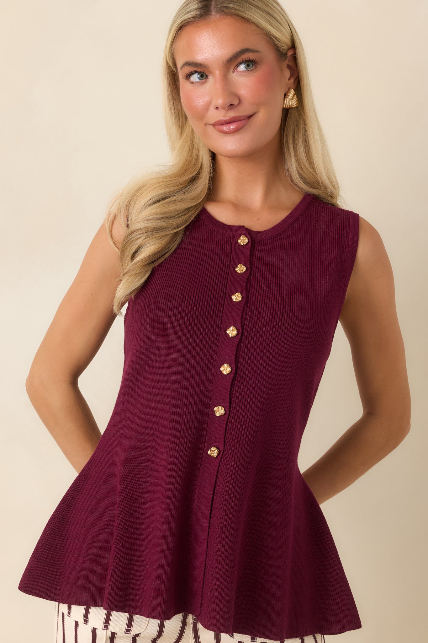 Detailed view of the gold-tone buttons highlighting the refined front placket and smooth knit texture.