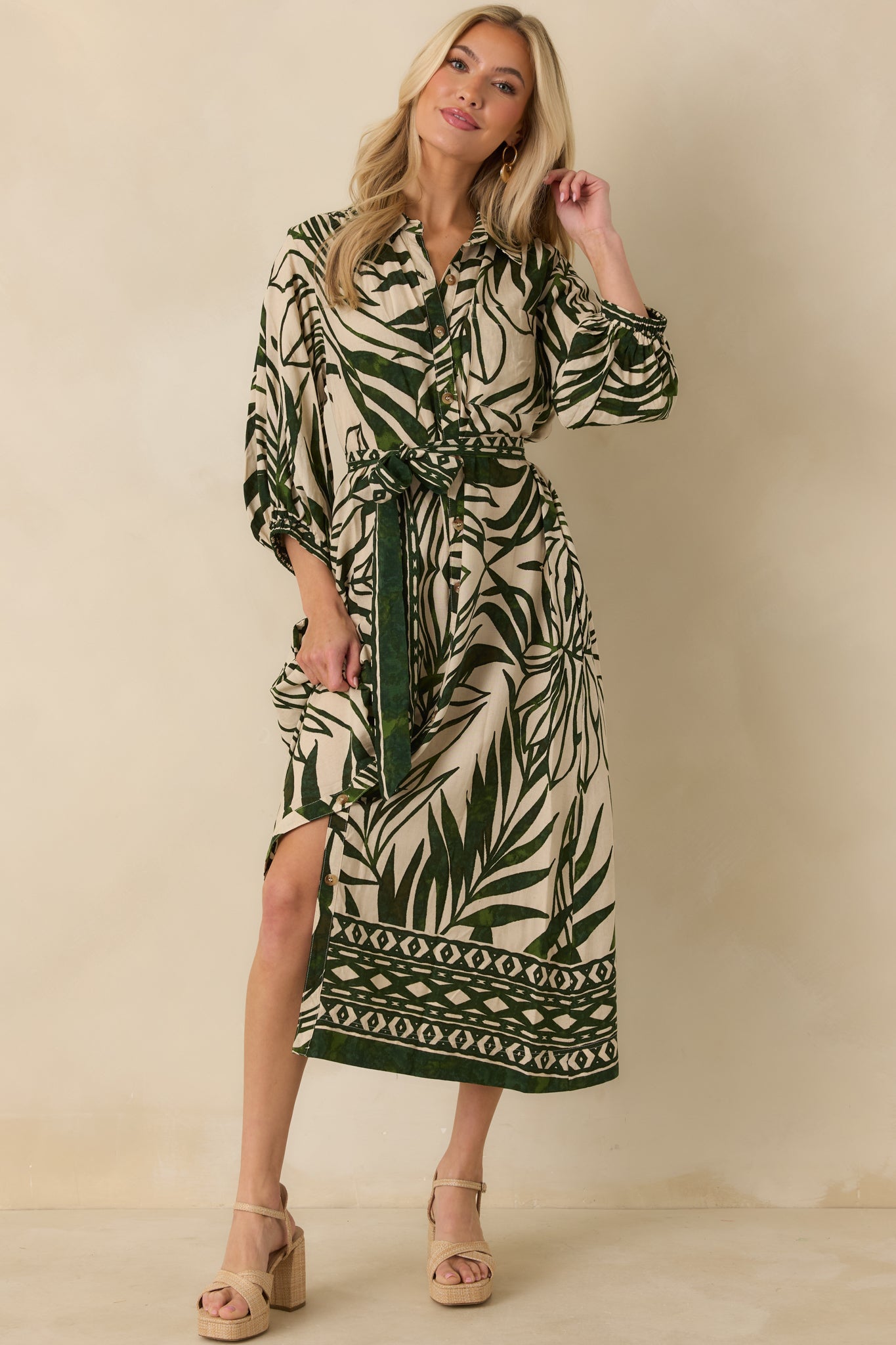 Green and beige maxi dress with flowing skirt, functional buttons, and relaxed tropical silhouette.
