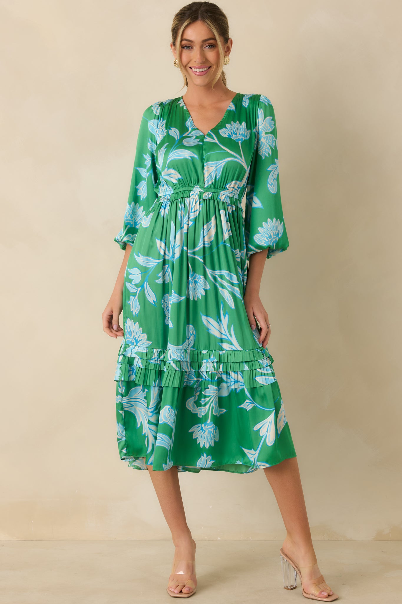 Straight-on front view of green and blue midi dress featuring tiered skirt layers and balloon sleeve design.