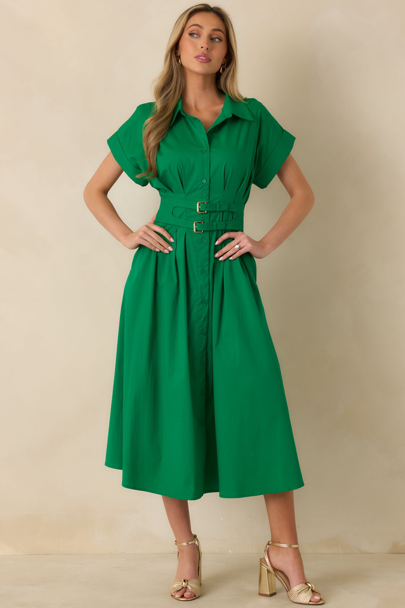 Green belted midi dress emphasizing the clean front buttons and relaxed, flowy shape.