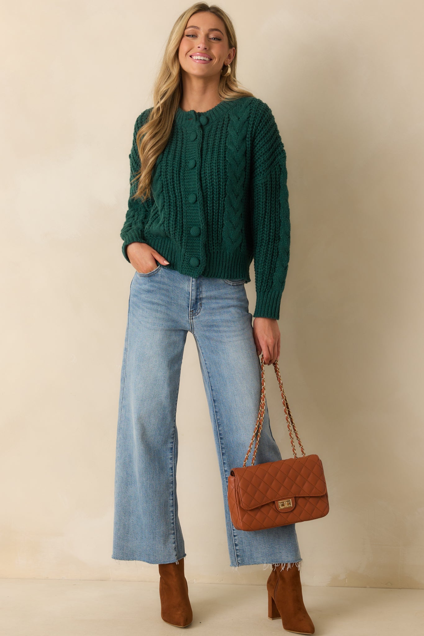 Long-sleeve green cardigan featuring ribbed hems and a functional button front with covered knit buttons.