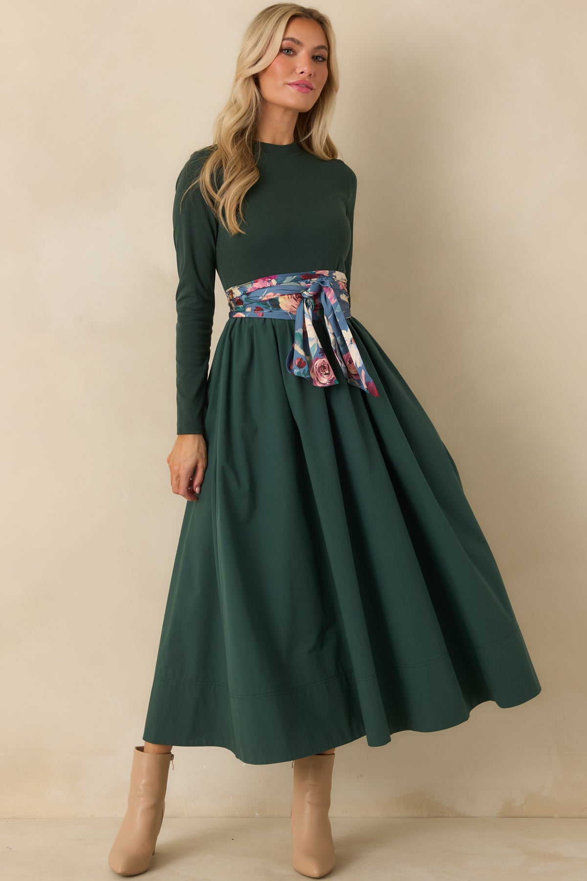 Green midi dress featuring a streamlined knit bodice and voluminous gathered cotton skirt with a wide A-line shape.