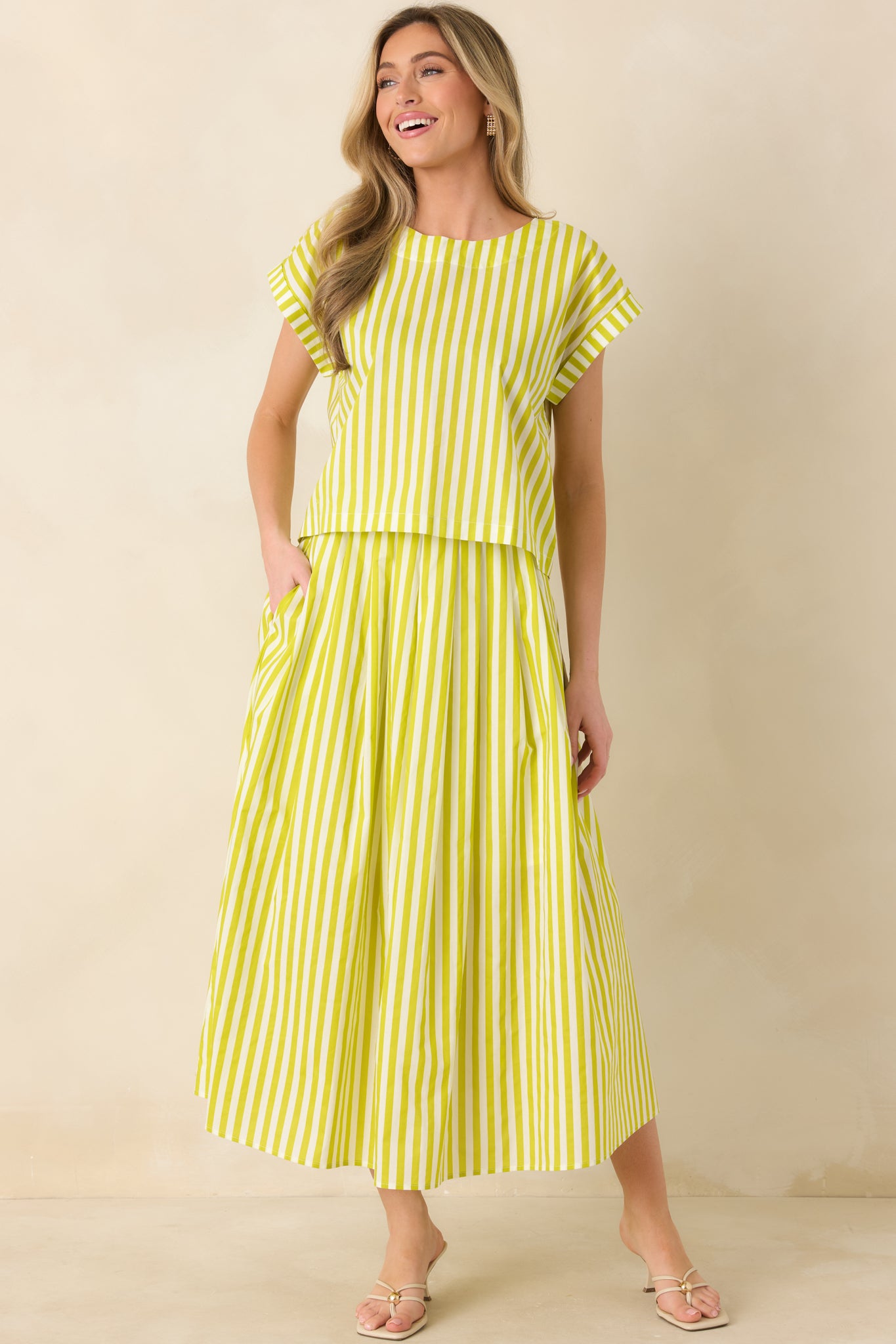 Green waist-length cotton top with crisp stripe detailing, short cuffed sleeves, and a modern boxy silhouette for easy everyday wear.