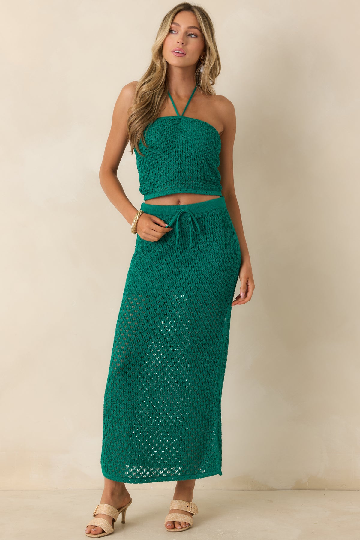 Green crochet halter top showcasing intricate knit detailing, adjustable tie straps, and a softly structured shape.