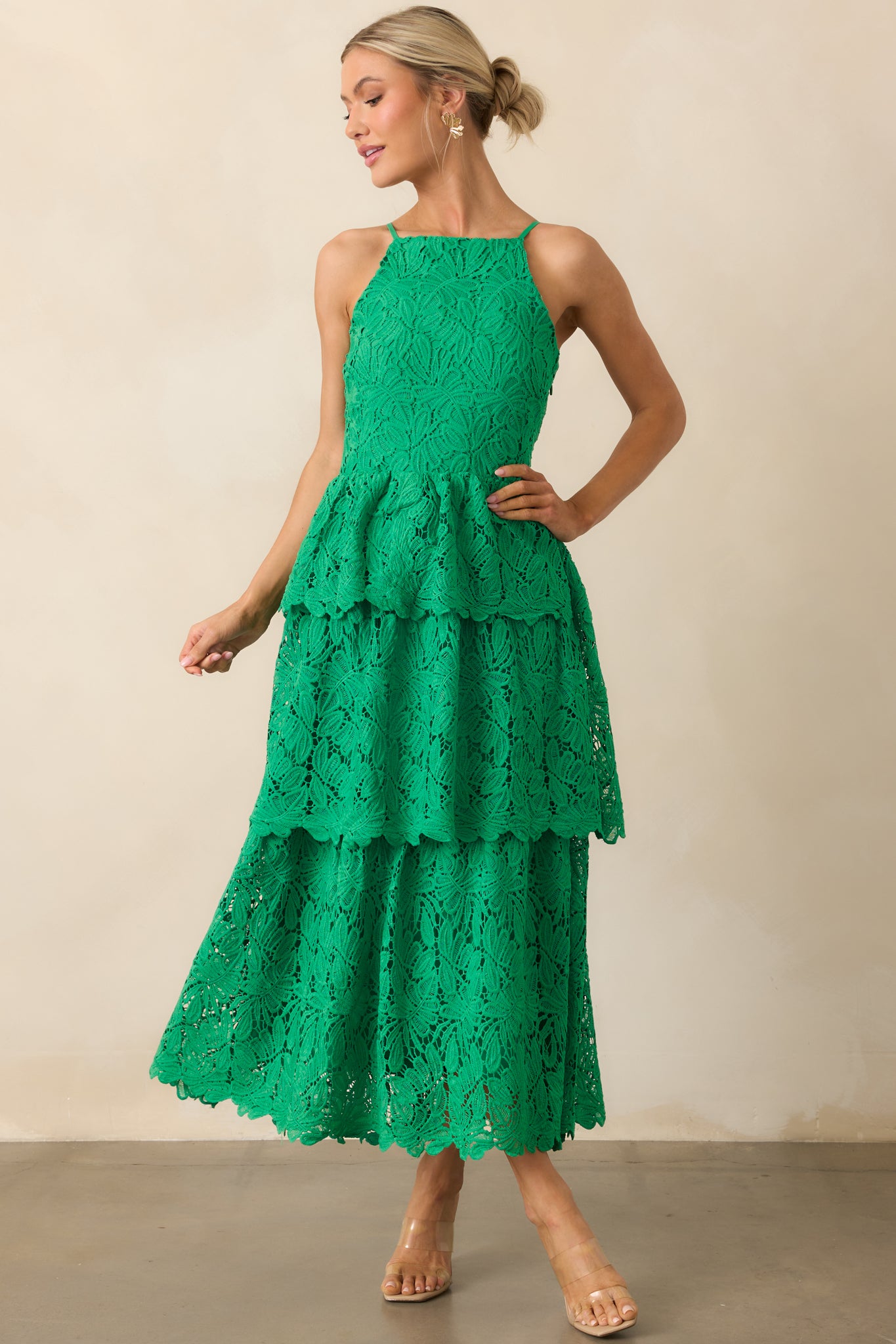 Green dress with apron neckline and tiered skirt, shown in a full-length front view.