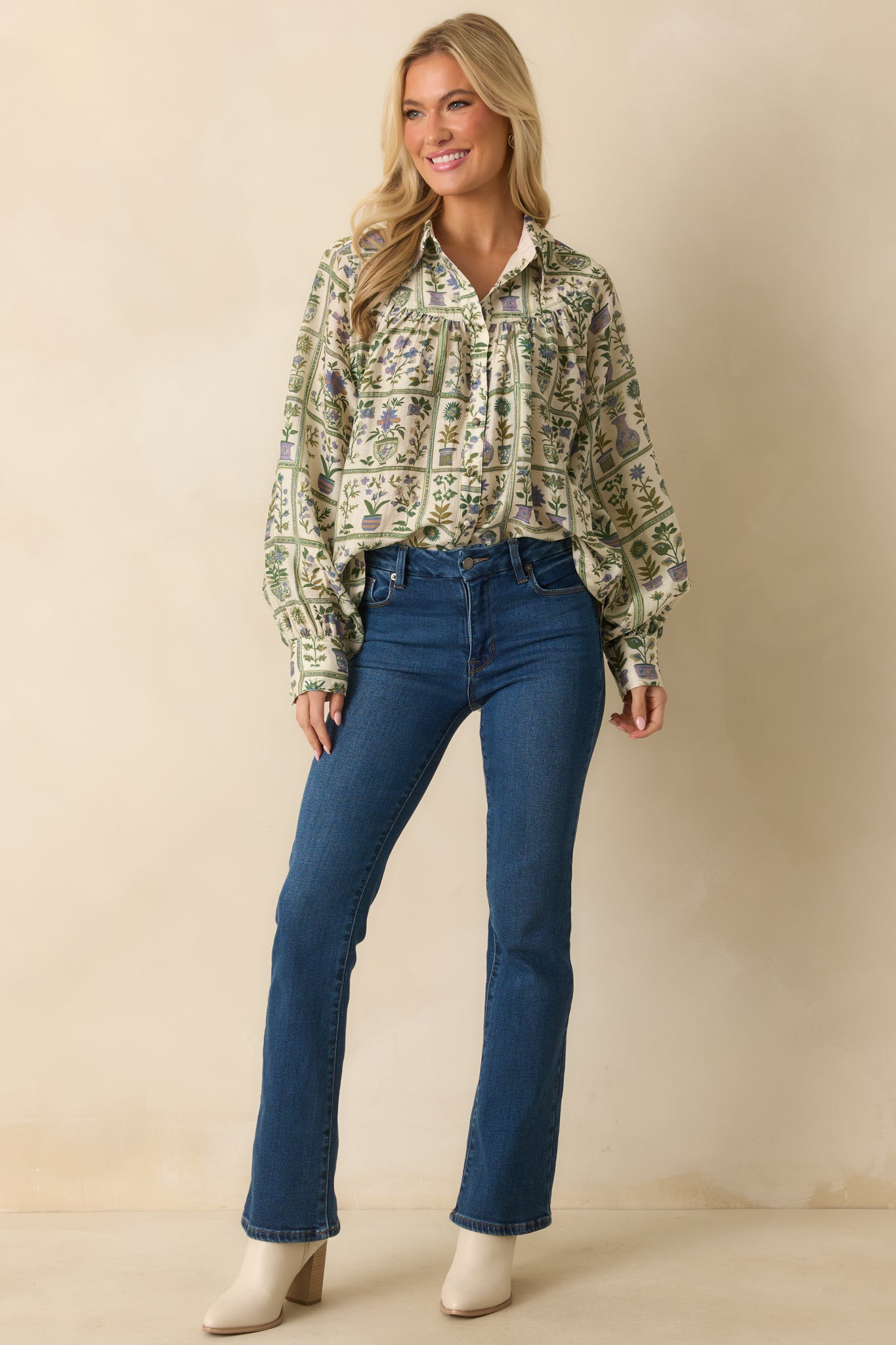 Button-front green floral blouse with flowing silhouette and neatly finished cuffs for a polished look.