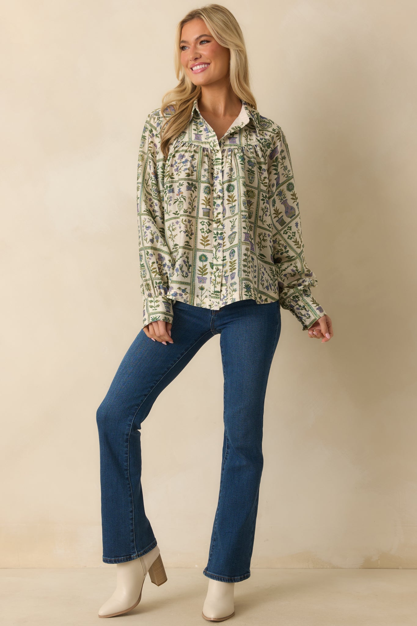 Floral print blouse in shades of green with gathered yoke detail and functional front buttons.