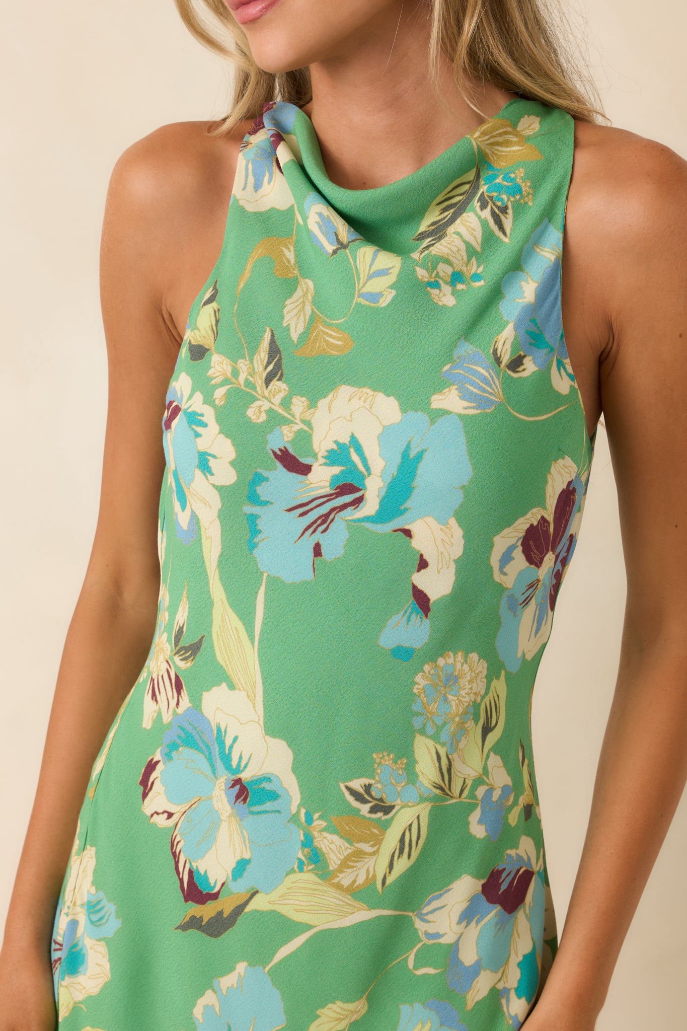 Close-up of the green floral print showcasing the lightweight viscose fabric and refined neckline detail.