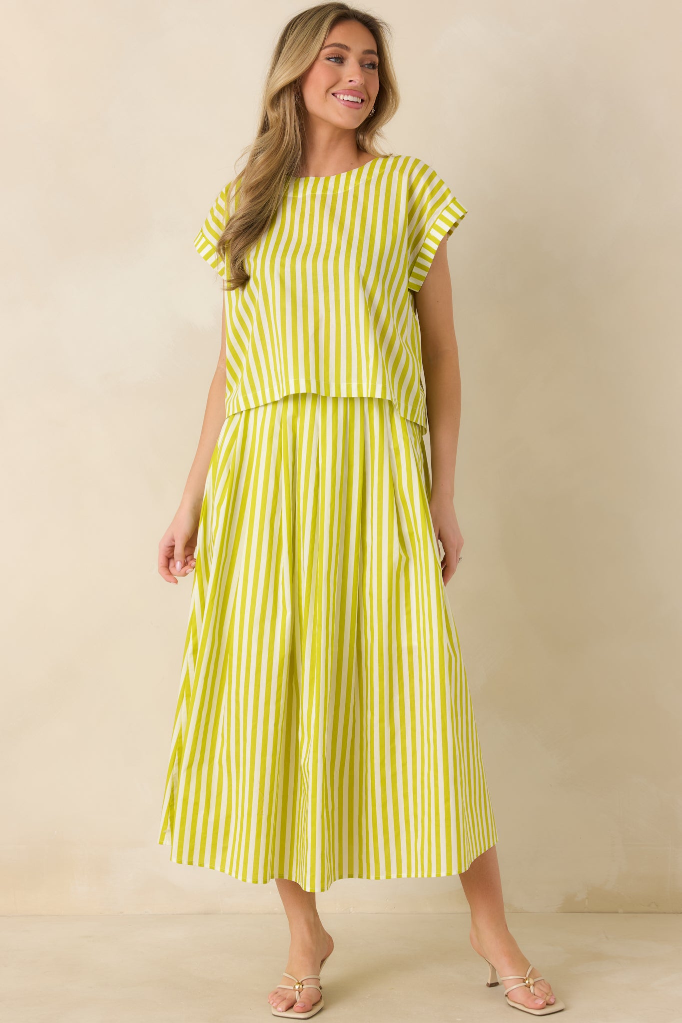 Full-body view of green high-waisted maxi skirt with vertical stripe detailing and full A-line silhouette.