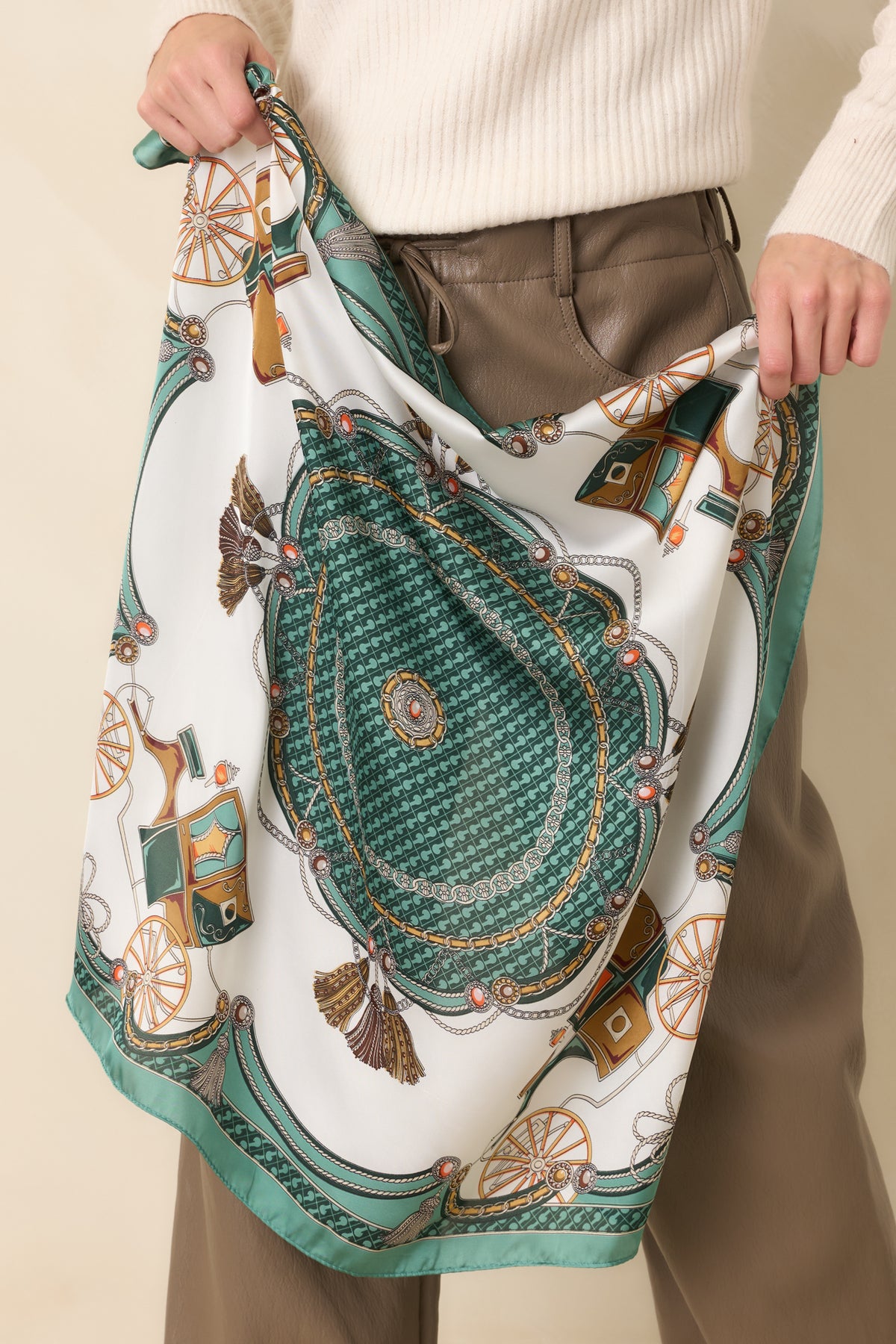 Green and ivory square scarf featuring an ornate carriage print with decorative chains, tassels, intricate medallions, and contrasting green geometric borders.