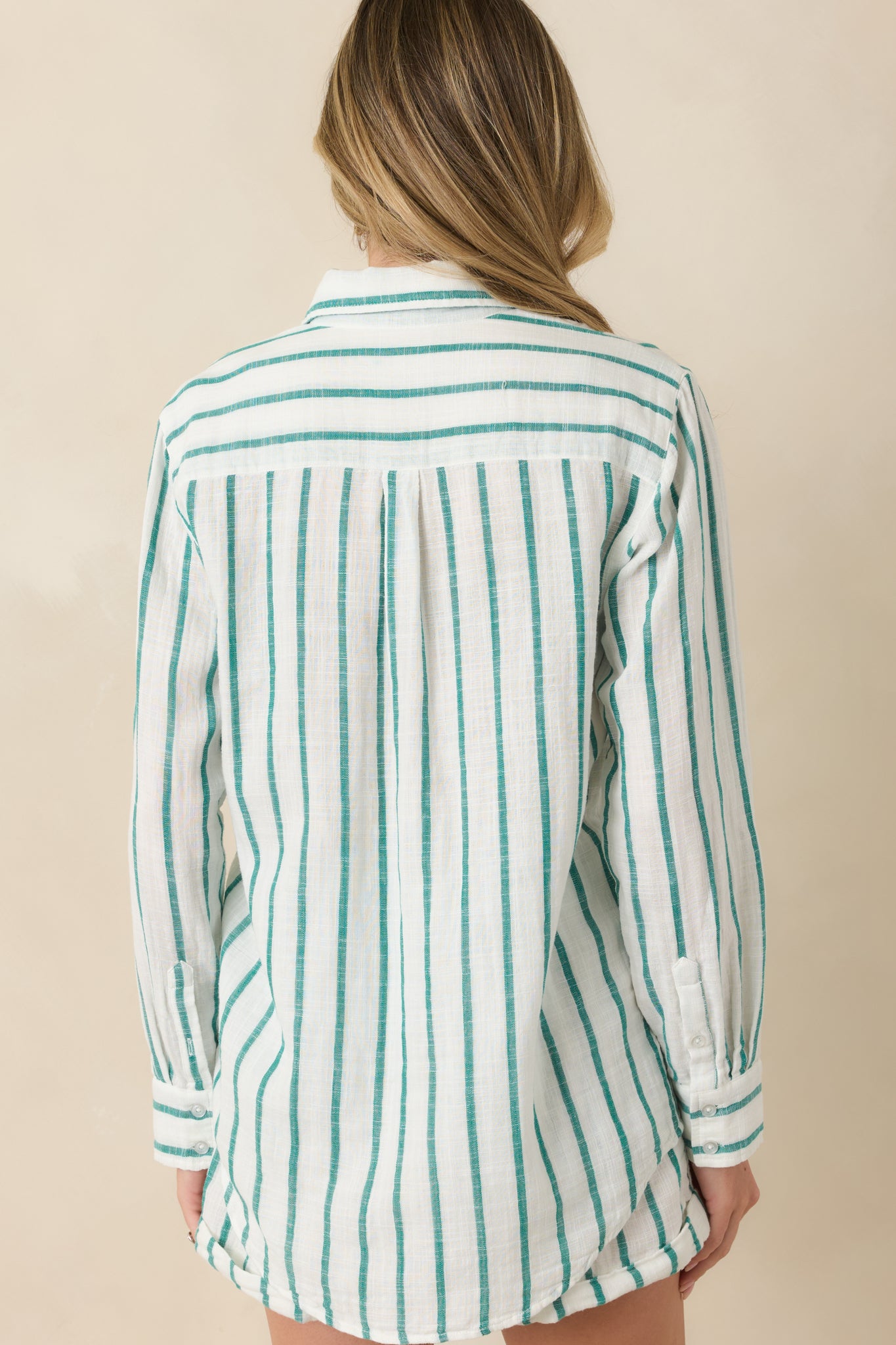 Back view of the green and ivory striped cotton gauze button-up top highlighting the relaxed silhouette and vertical stripe pattern.
