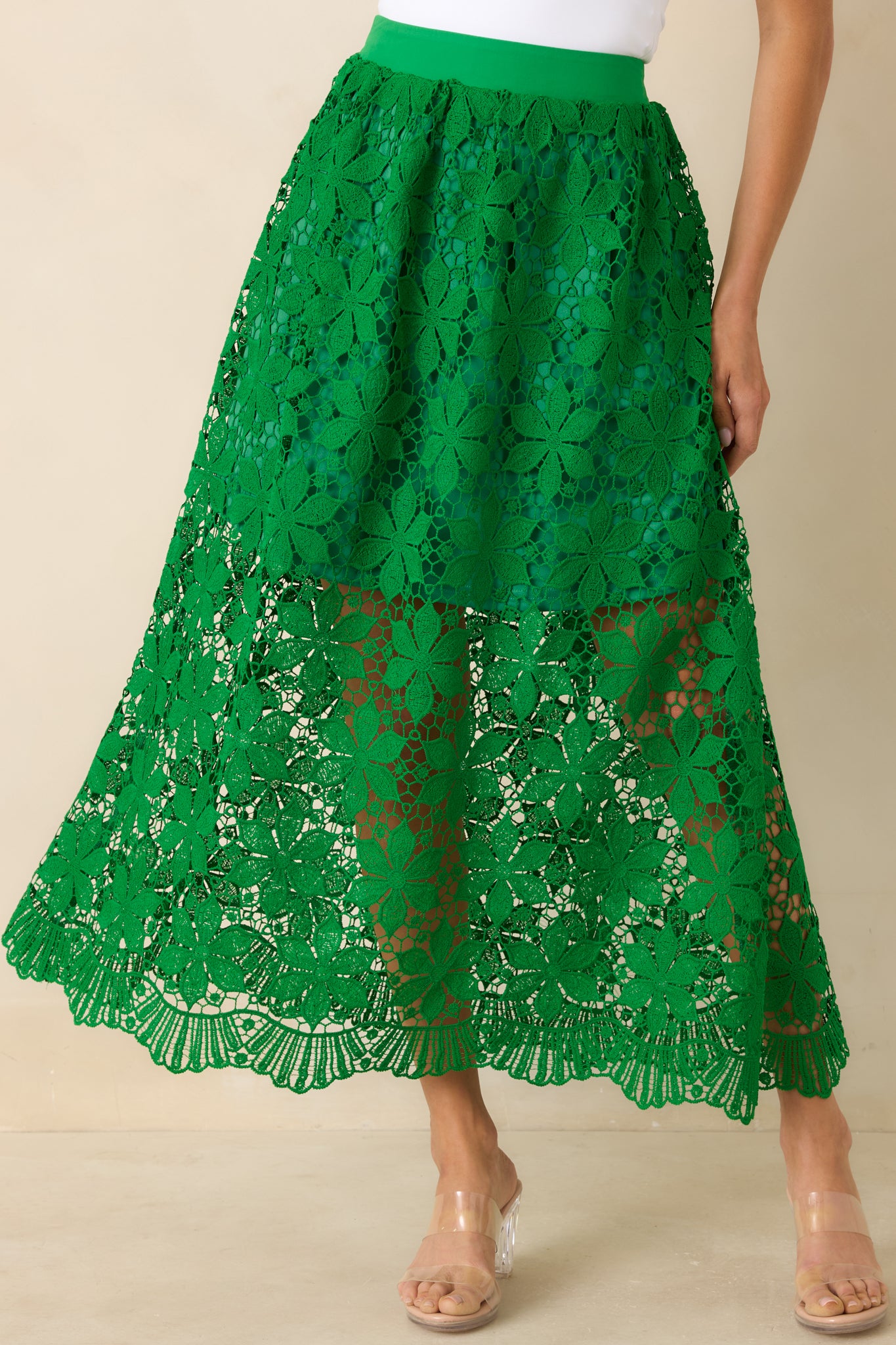 Green lace skirt with elastic waistband and textured crochet pattern.