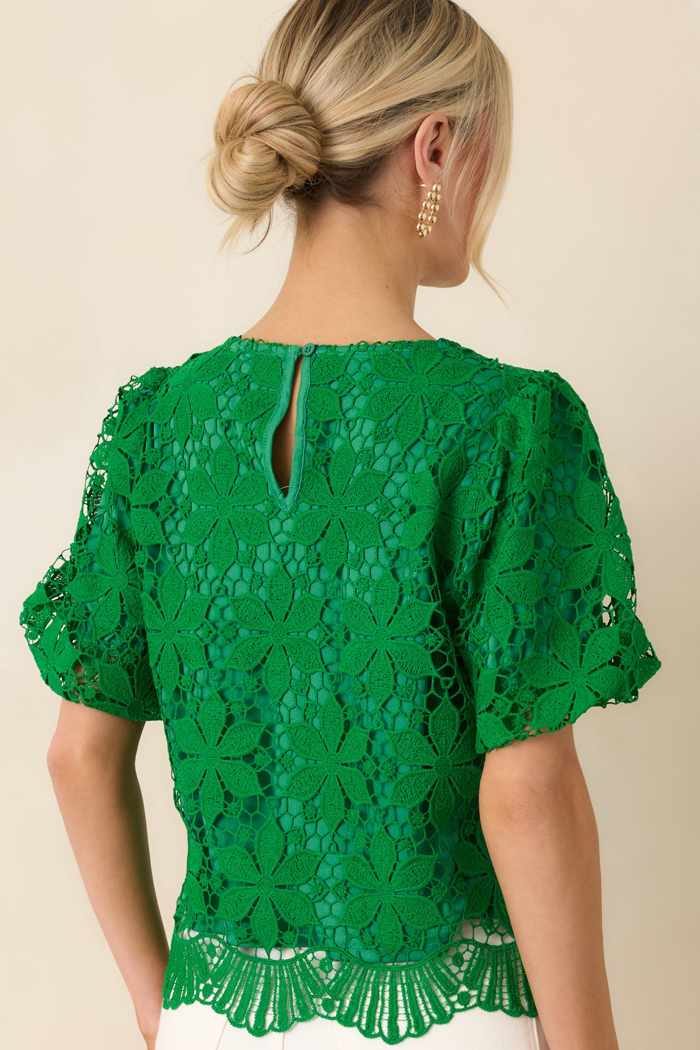 Green lace top with floral crochet overlay and smooth rear finish.