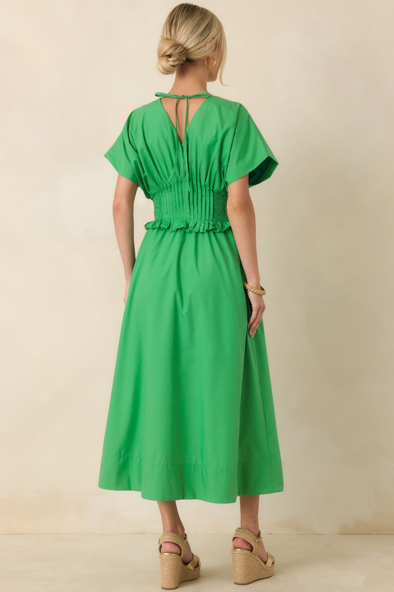 Back view of the green maxi dress highlighting the relaxed A-line silhouette and waistband.
