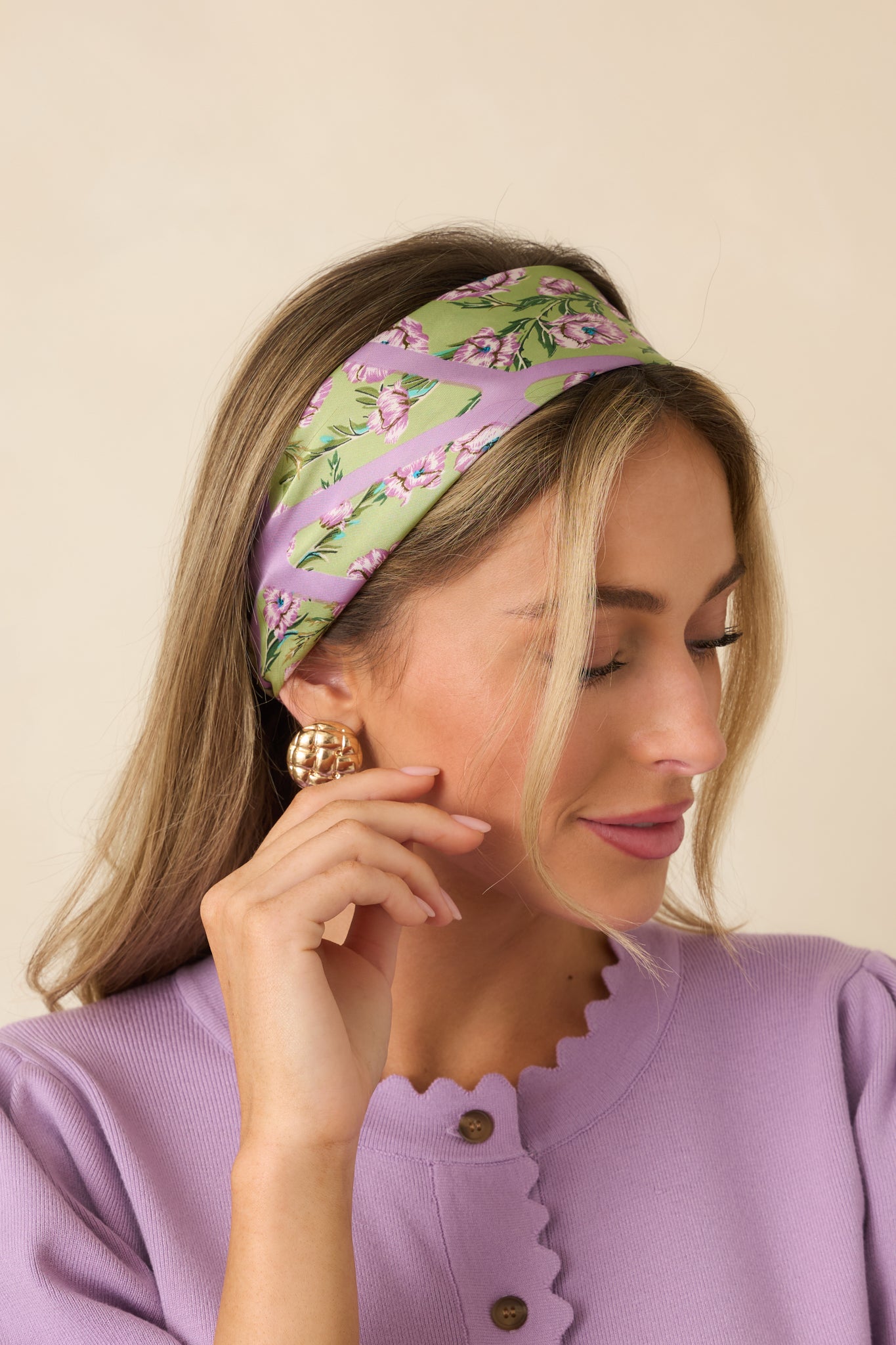 Green multicolor scarf with floral and geometric layers, lavender blossoms on a green base, lattice detail, and a deep green striped border.