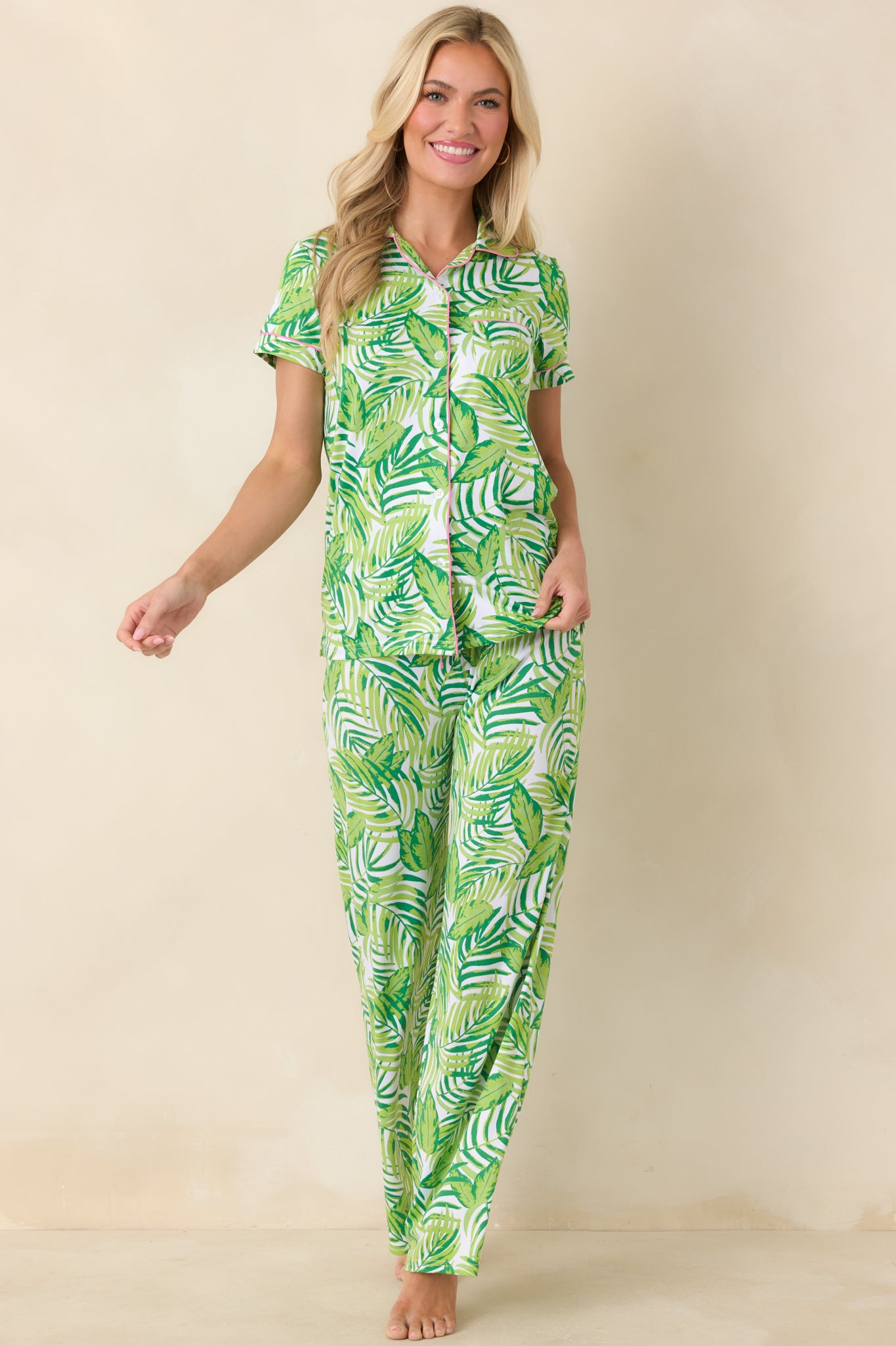 Green palm and leaf print pants with relaxed straight-leg silhouette, elastic waistband, and adjustable drawstring tie