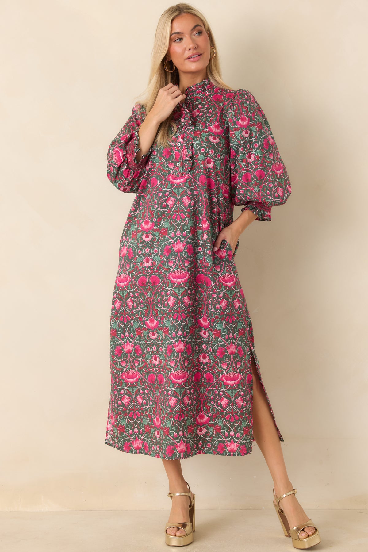 Green floral midi dress with pink blooms, a ruffled stand collar, and a straight silhouette.