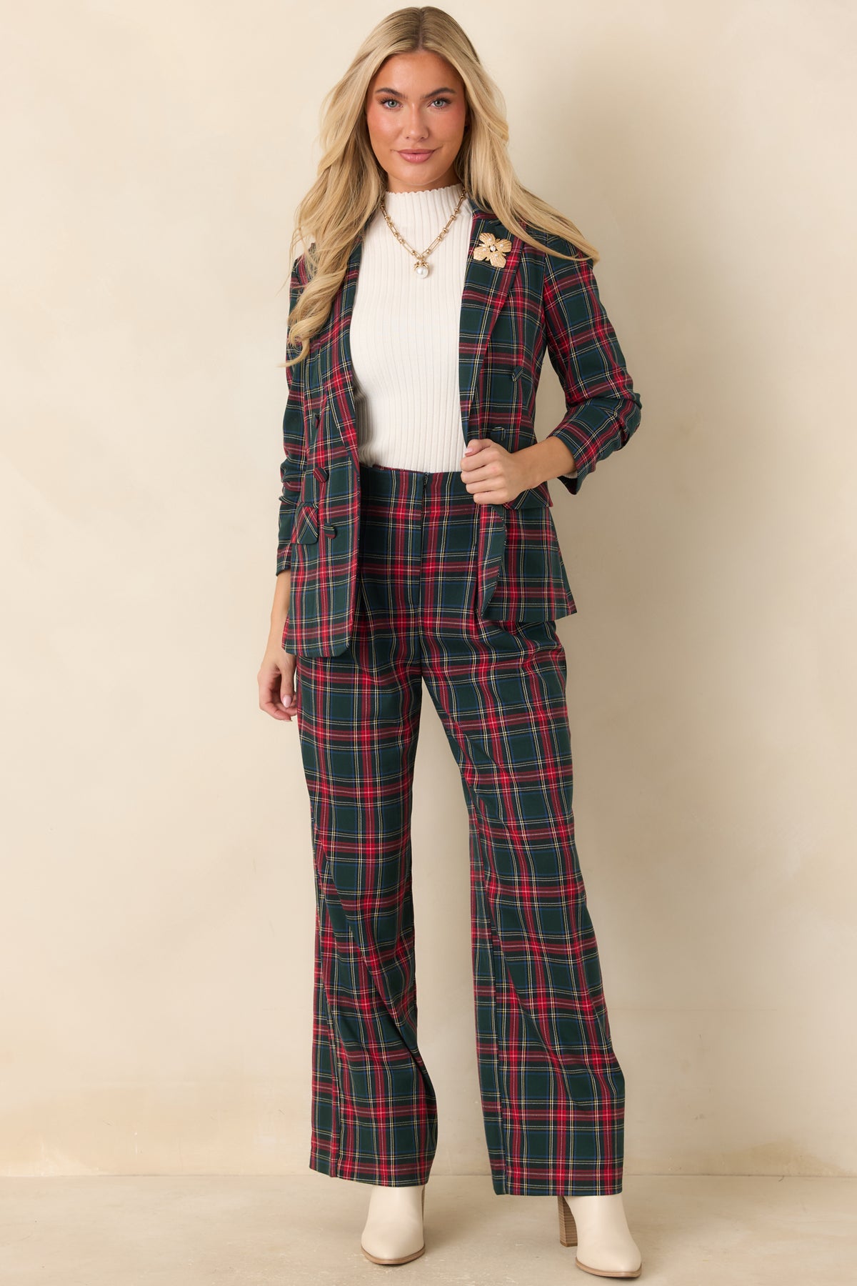 Green plaid trousers featuring a high waist, front pleats, and wide legs with a full-length silhouette.
