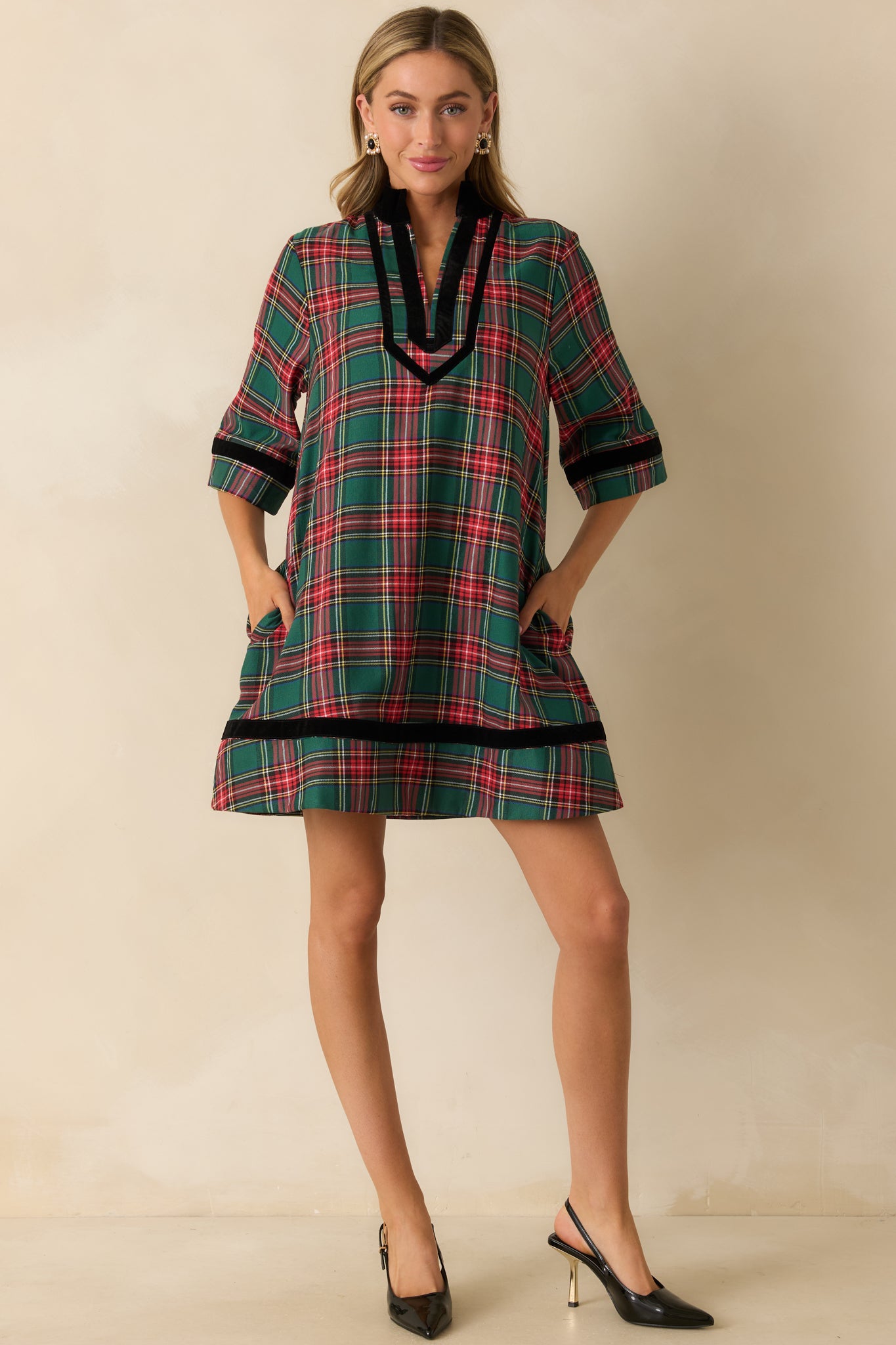 Green plaid mini dress with split neckline, elbow-length sleeves, side pockets, and relaxed A-line fit.