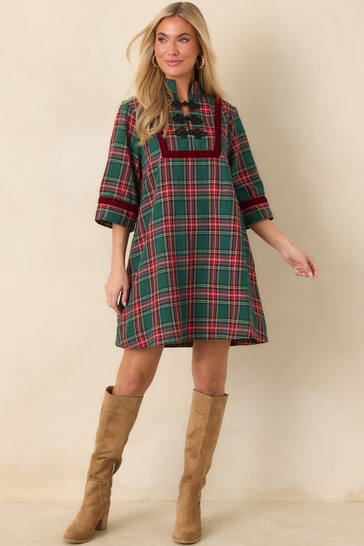 Green and red plaid dress with a structured stand collar and decorative black braided closures.