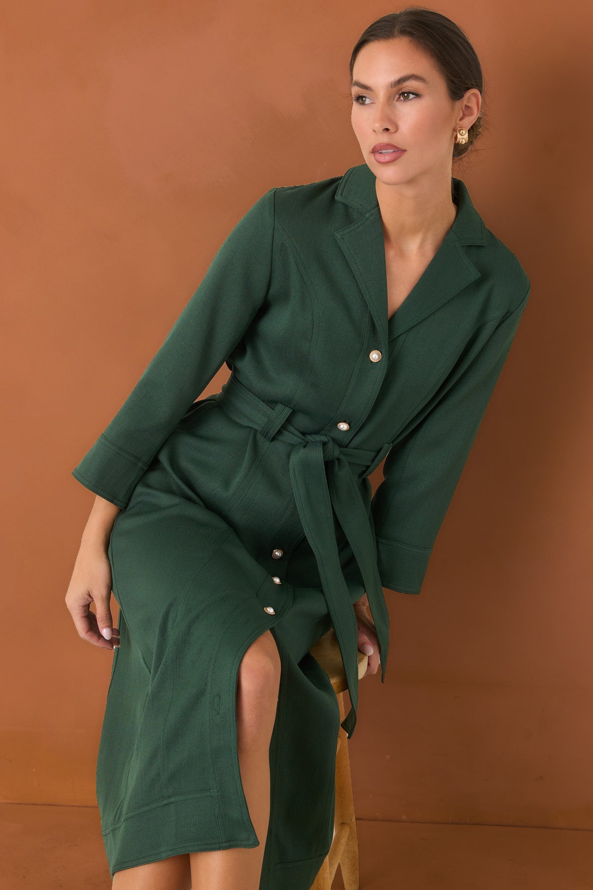 Green midi dress showcasing the removable tie belt and polished gold-tone pearl buttons.
