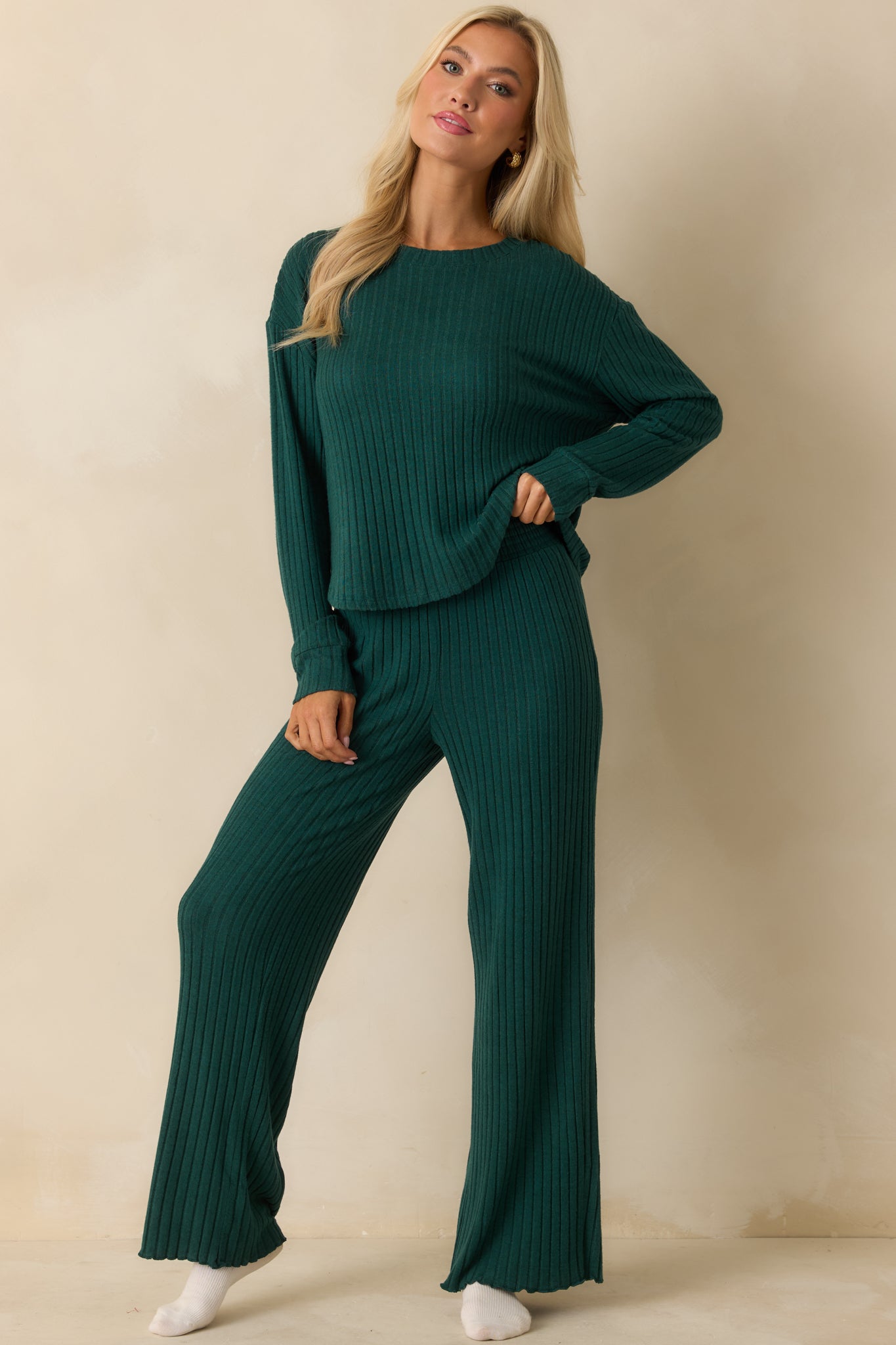Front view of green ribbed pants featuring midweight stretch fabric, flared legs, and comfortable high-rise fit.