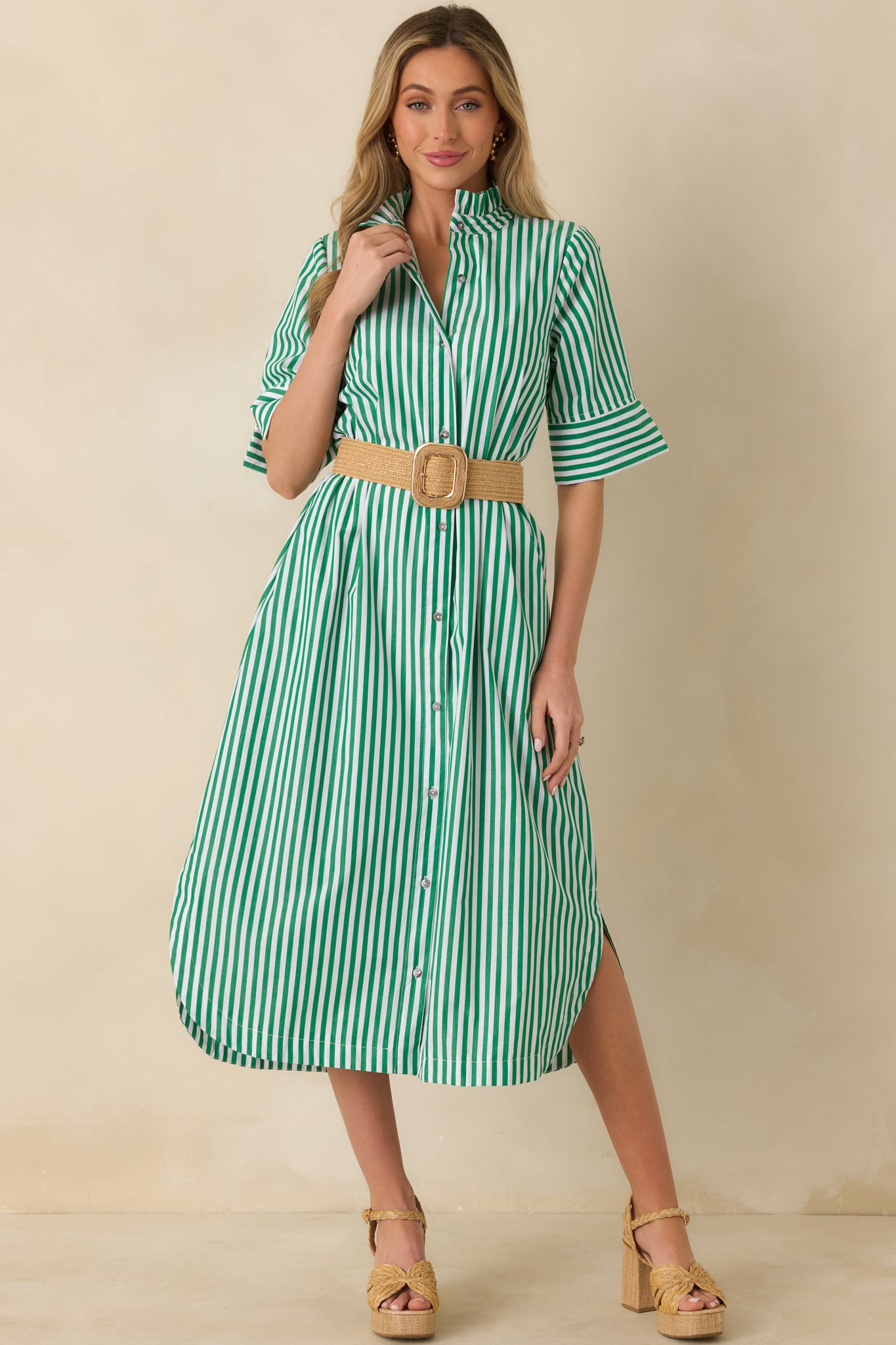 Green striped button-front midi dress emphasizing the shirttail hemline and fluid drape.