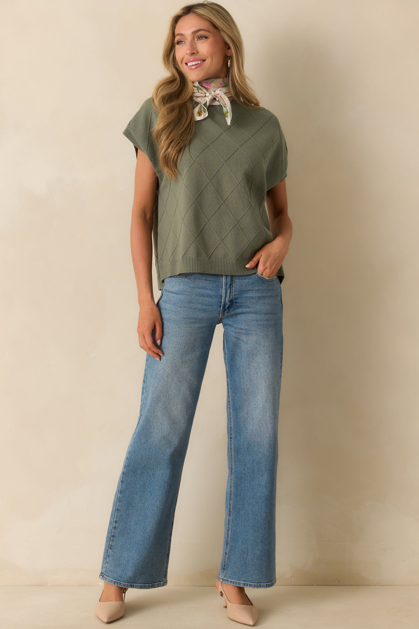 Green sweater with crew neckline featuring rolled hem, short dolman sleeves, and straight bottom hem.