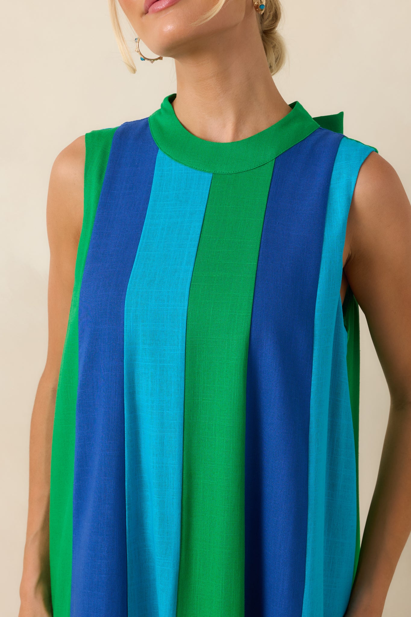 Detailed view of the green, turquoise, and cobalt blue colorblock panels and lightweight flowing fabric.