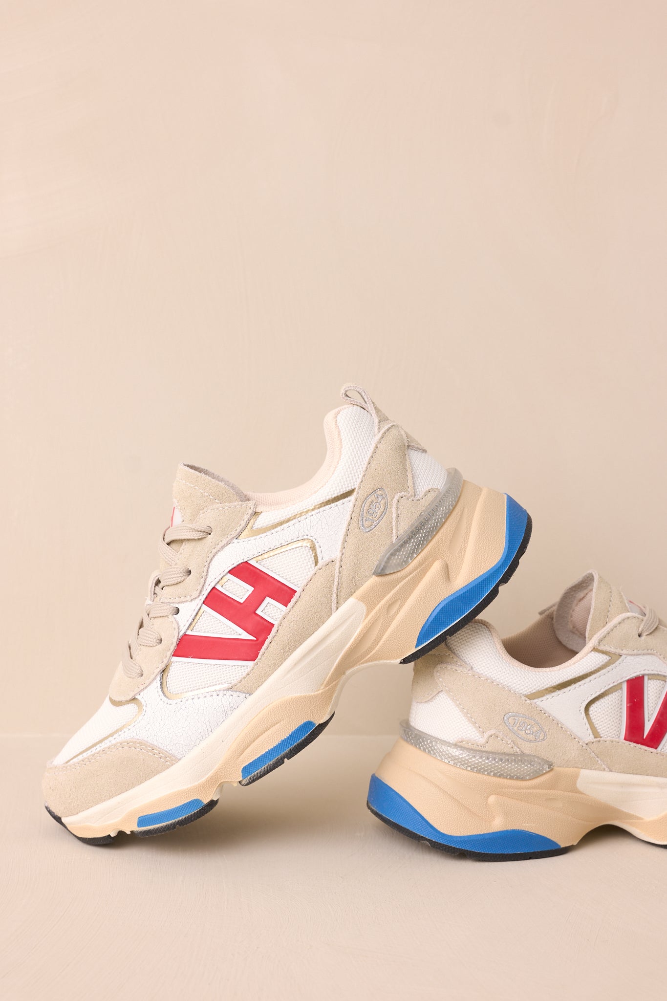 Side view highlighting the grey and beige color blocking with the large red VH symbol on the side.