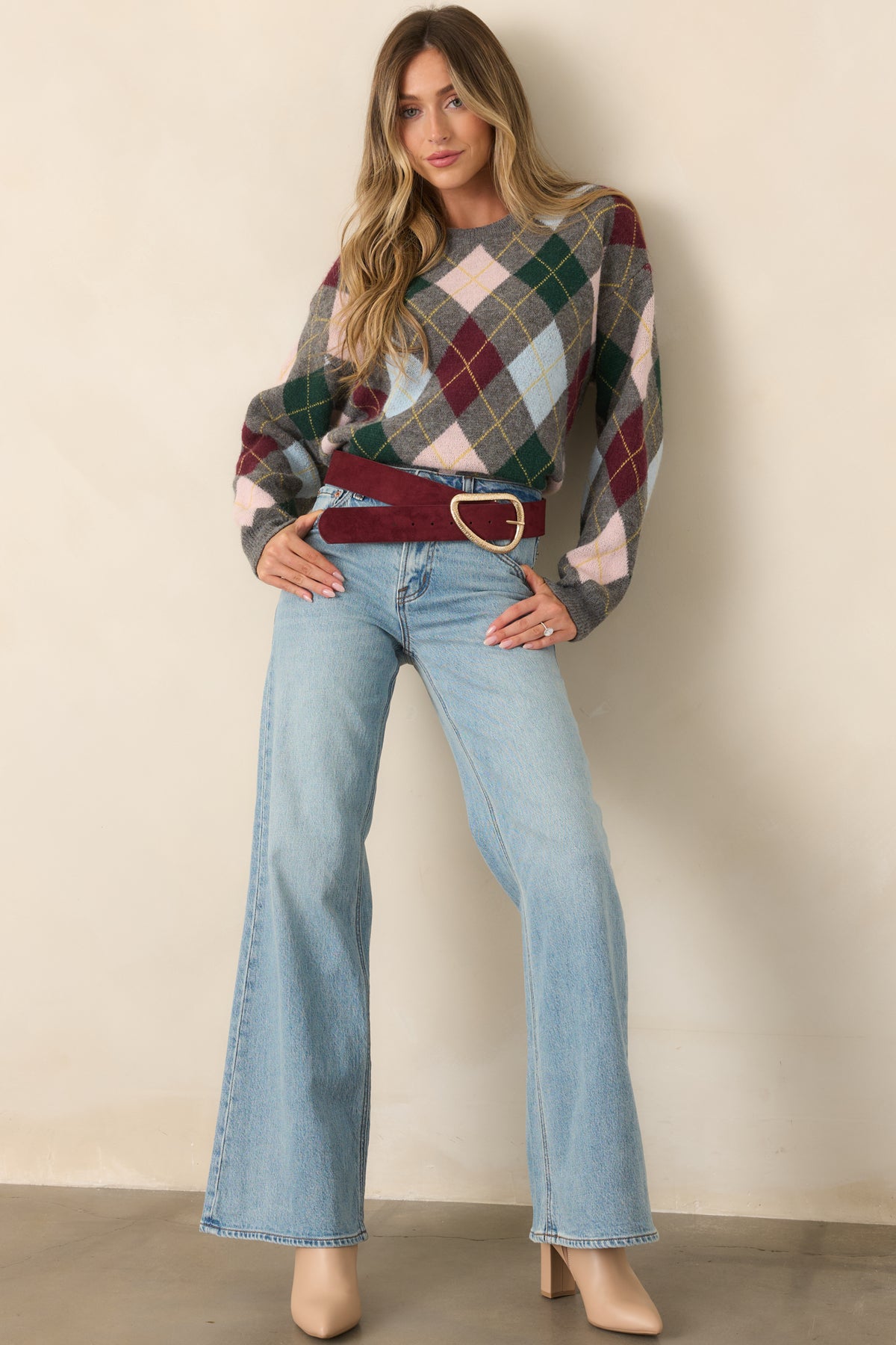 Grey knit top showcasing colorful argyle diamonds in burgundy, green, blush, blue, and golden yellow.