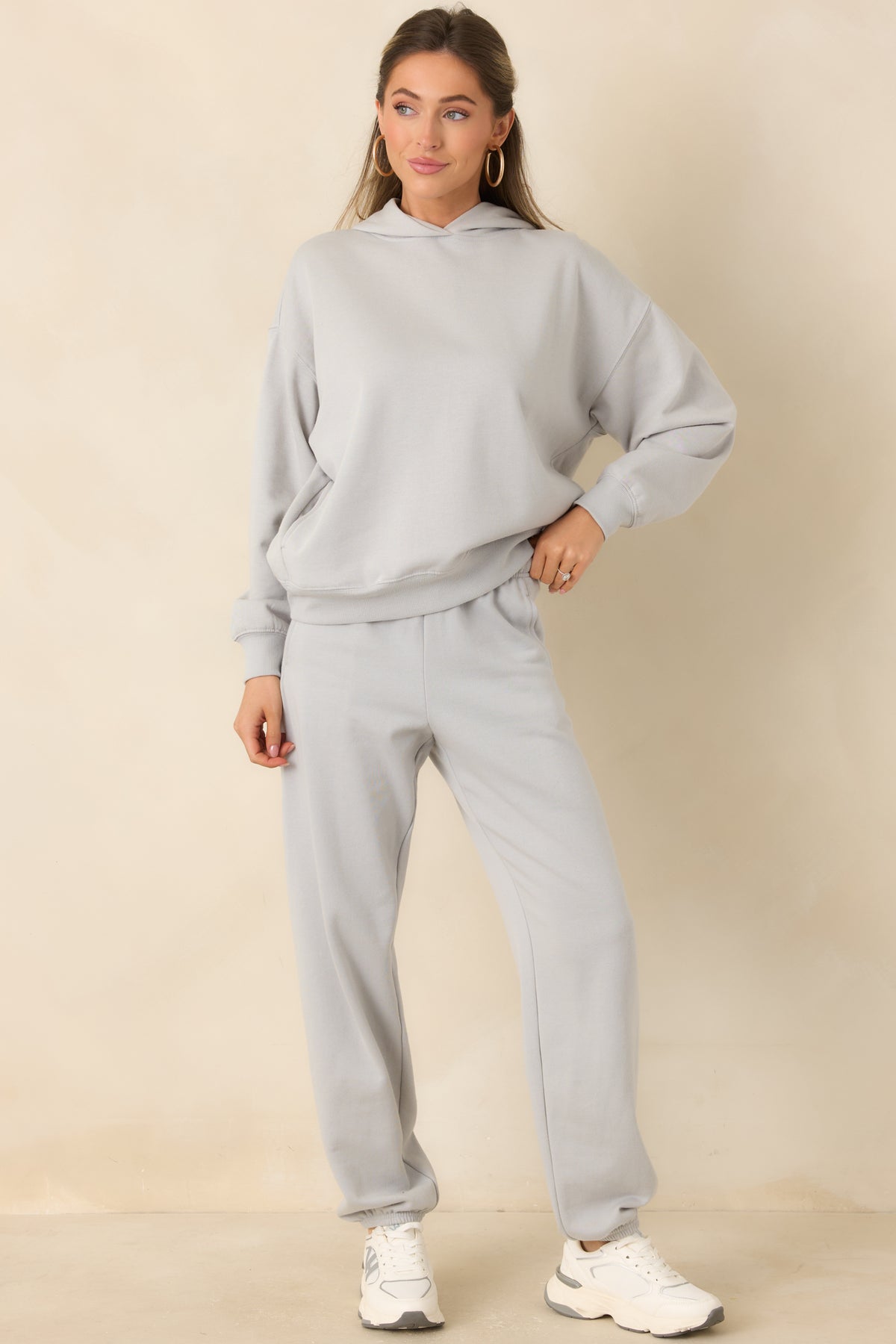 Soft grey fleece pants with a relaxed silhouette and gathered elastic cuffs at the ankles.