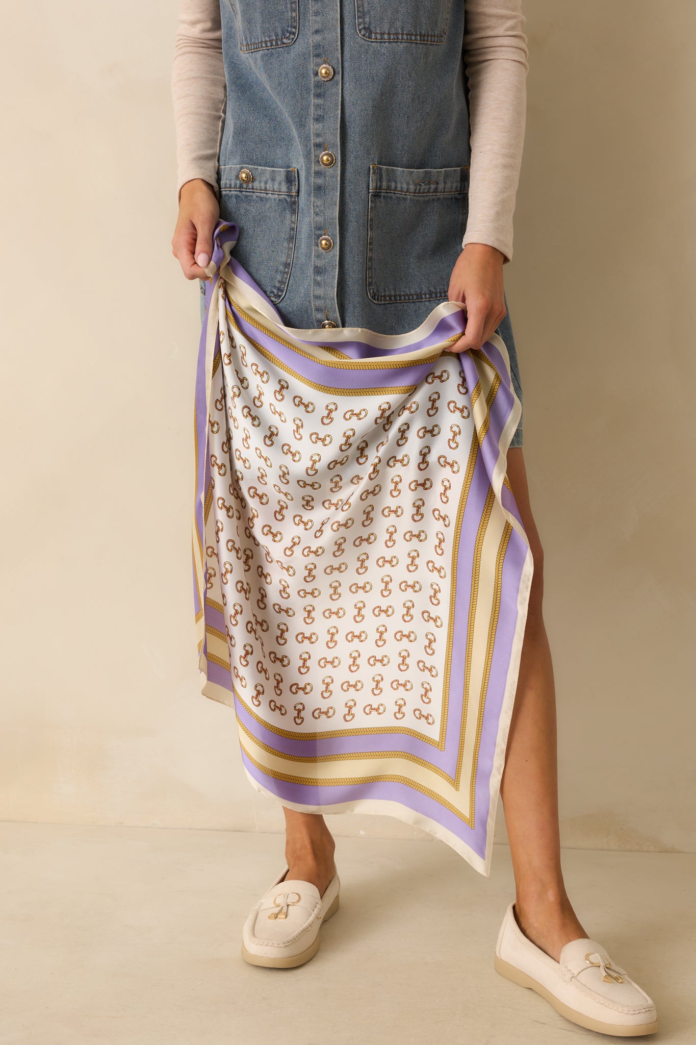 Hair scarf showing the square shape, satin finish, and equestrian-inspired gold pattern.