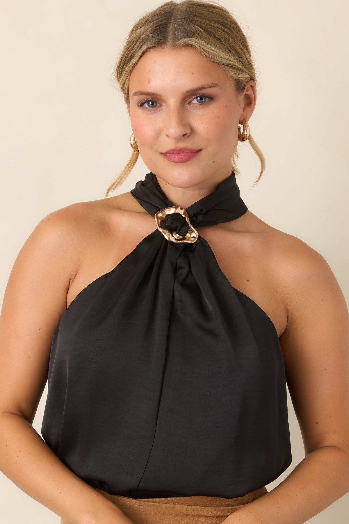 Halter neckline top highlighting the gathered front and decorative ring accent.