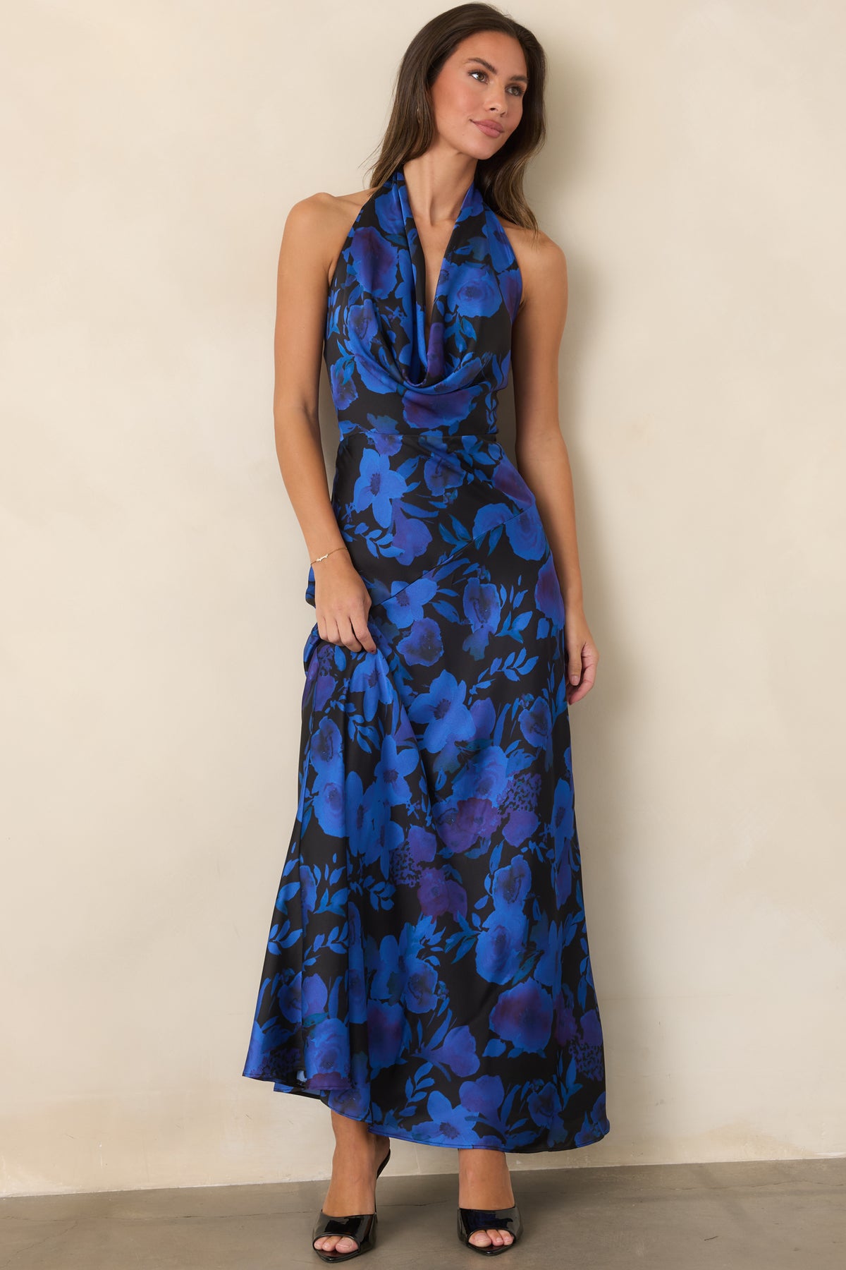 Halter satin maxi dress featuring a vibrant cobalt and violet floral pattern and flowing full-length skirt.