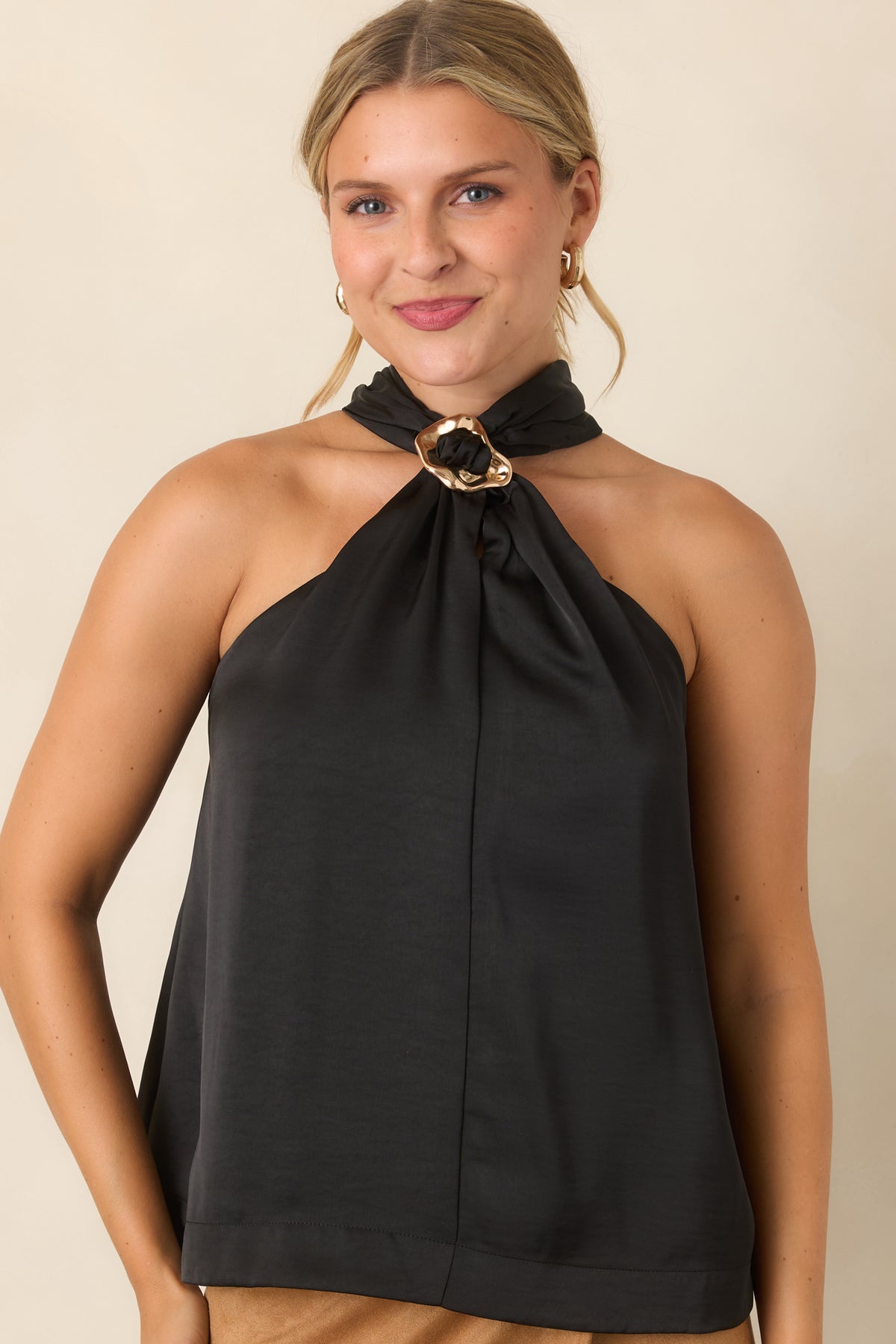 Halter top featuring gathered fabric and a statement ring neckline detail.