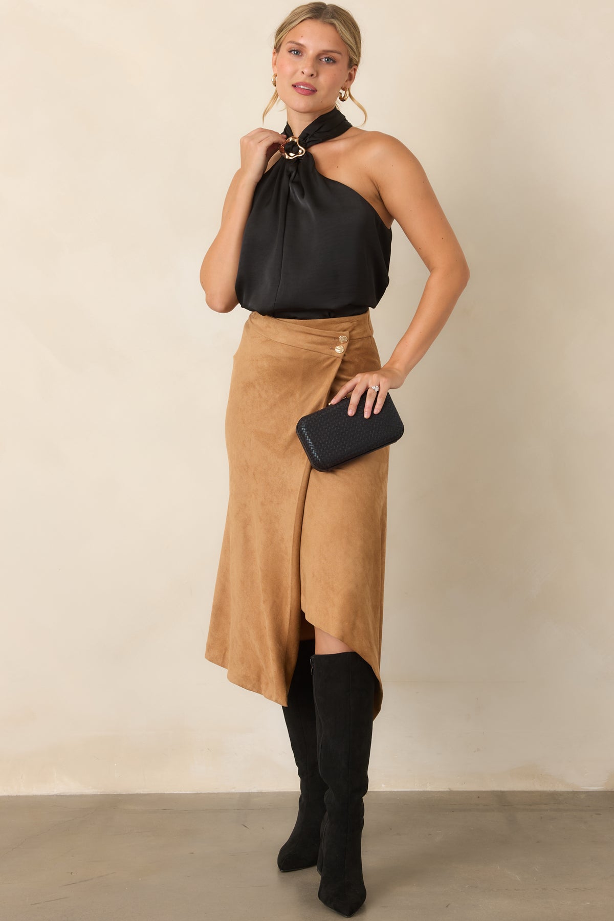 Halter top showcasing gathered detailing through the front and an exposed shoulder design.