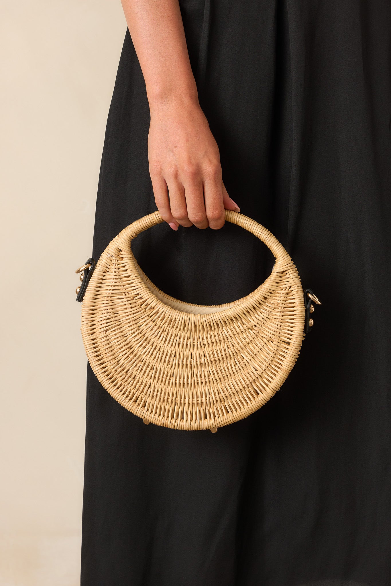 Handbag shown from a distance, highlighting its open-top design, rounded handle, and balanced mix of natural texture and sleek black detailing.