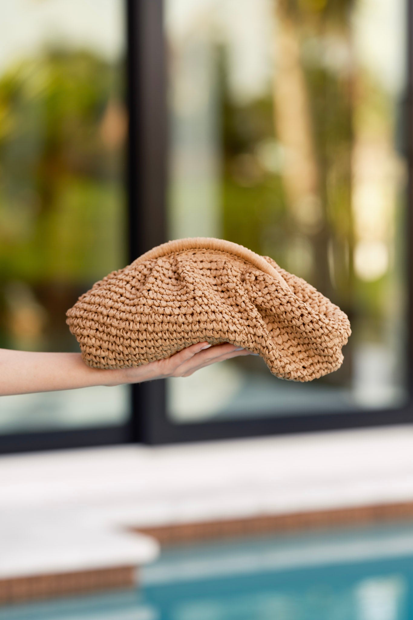 Closer look at the handbag’s top section, showing the hinge clasp closure and hints of the gold crossbody chain.