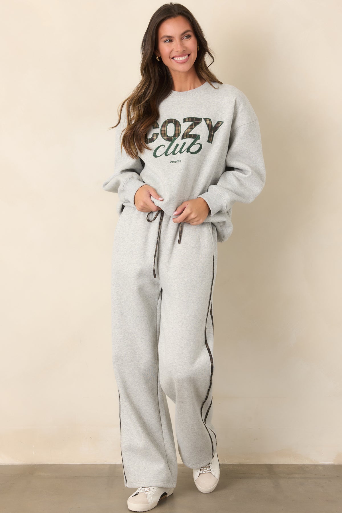 Heather grey straight-leg sweatpants showcasing understated plaid stripes and an adjustable elastic waistband.