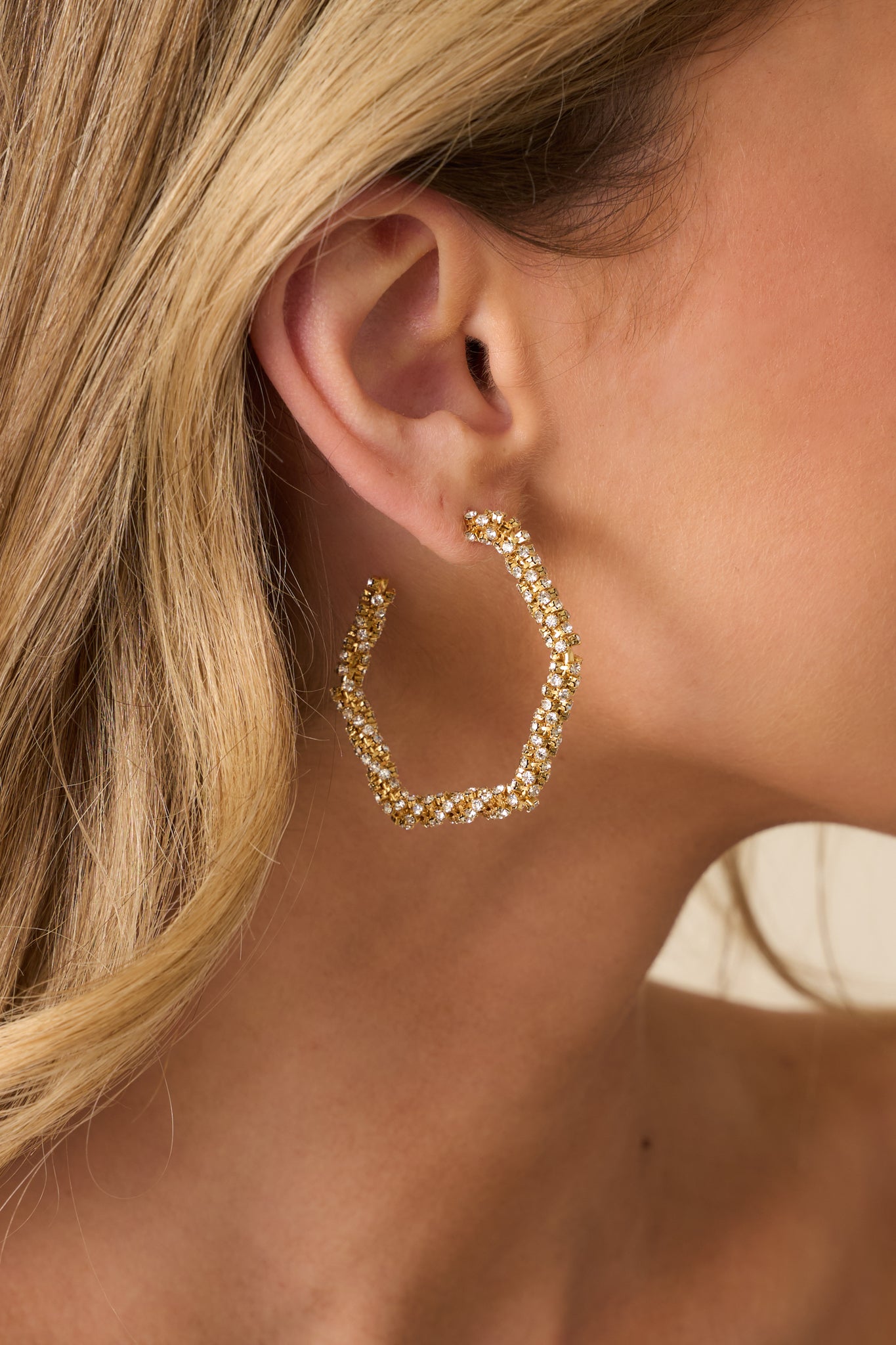 Close-up detail photo capturing the hexagonal shape, rhinestone sparkle, and post backing hardware of the earrings.