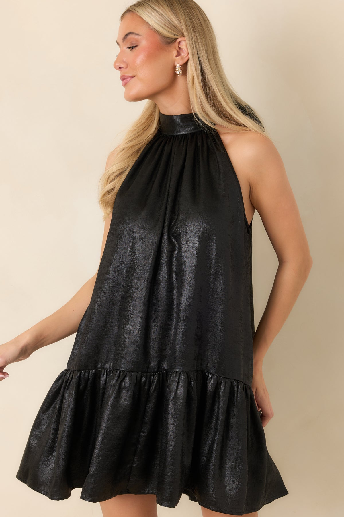 High halter neckline with gathered fabric flowing into the dress bodice.