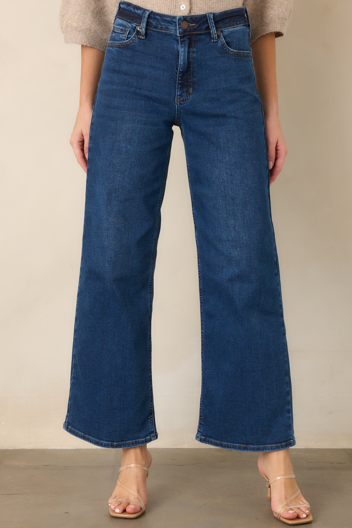 High-rise cropped jeans featuring a button and zipper closure with belt loops.