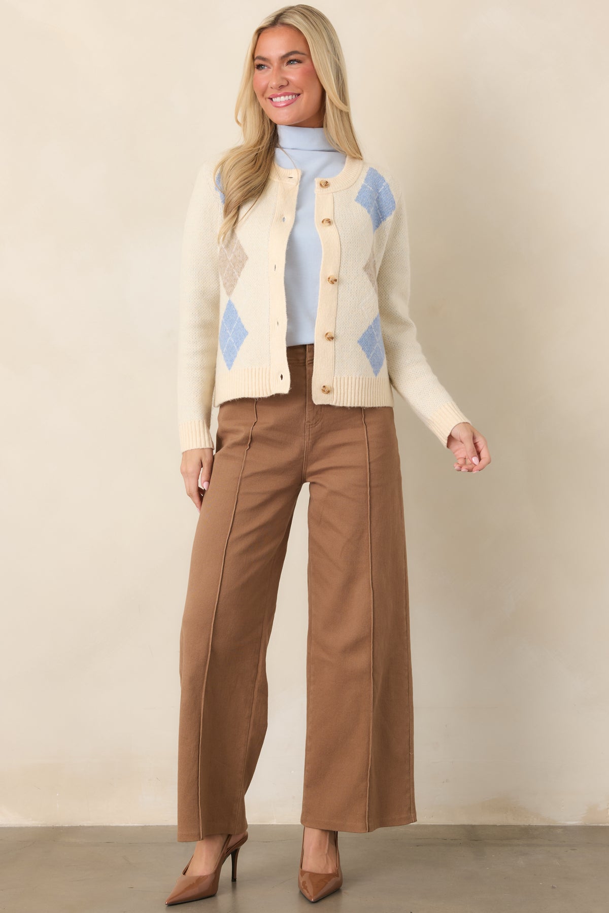 Versatile high-rise trousers showcasing crisp front pleats, a smooth waistband, practical belt loops, and a polished everyday shape.