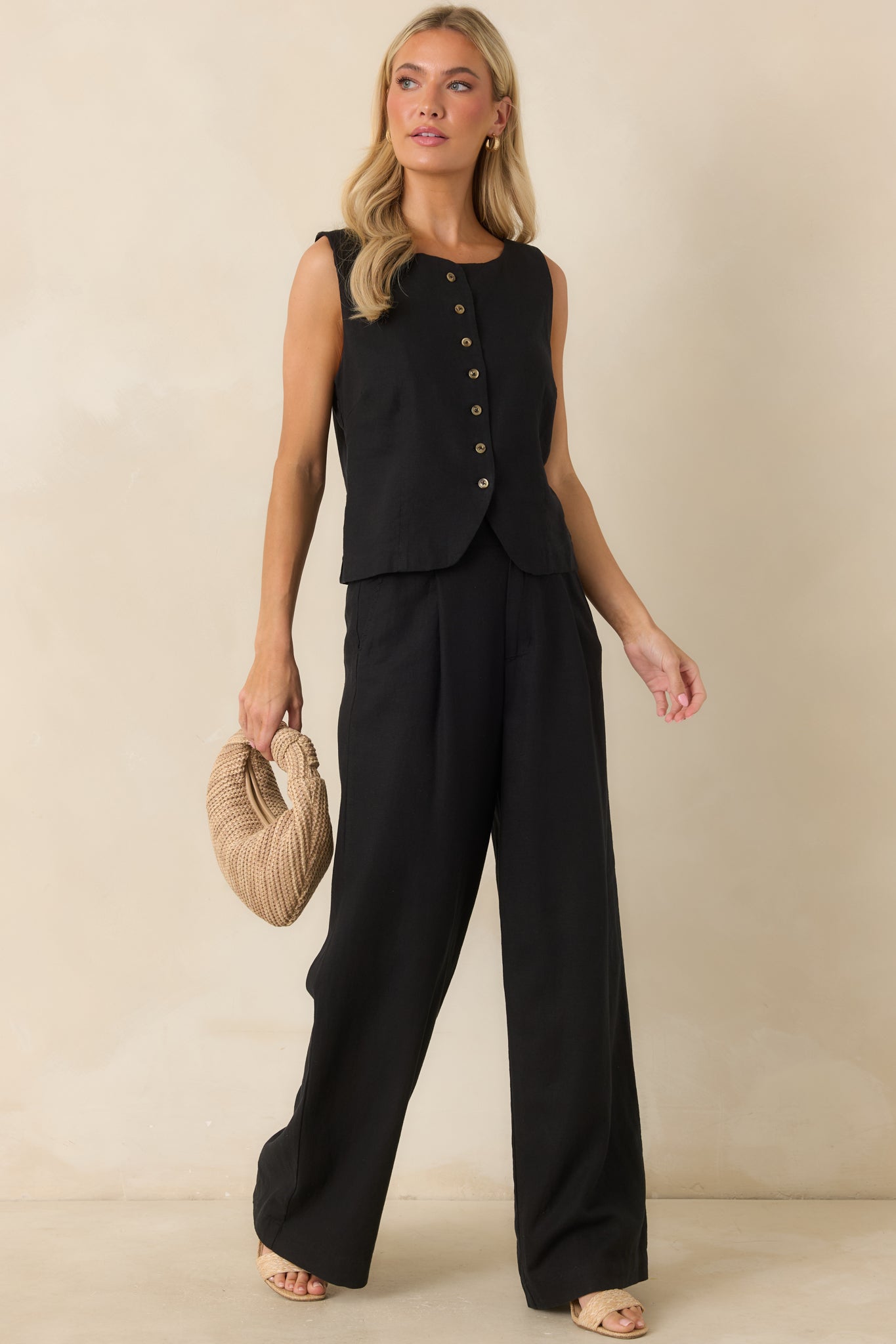 High-rise black linen blend pants designed with a straight-leg fit, side seam pockets, and a clean zip fly with button closure.