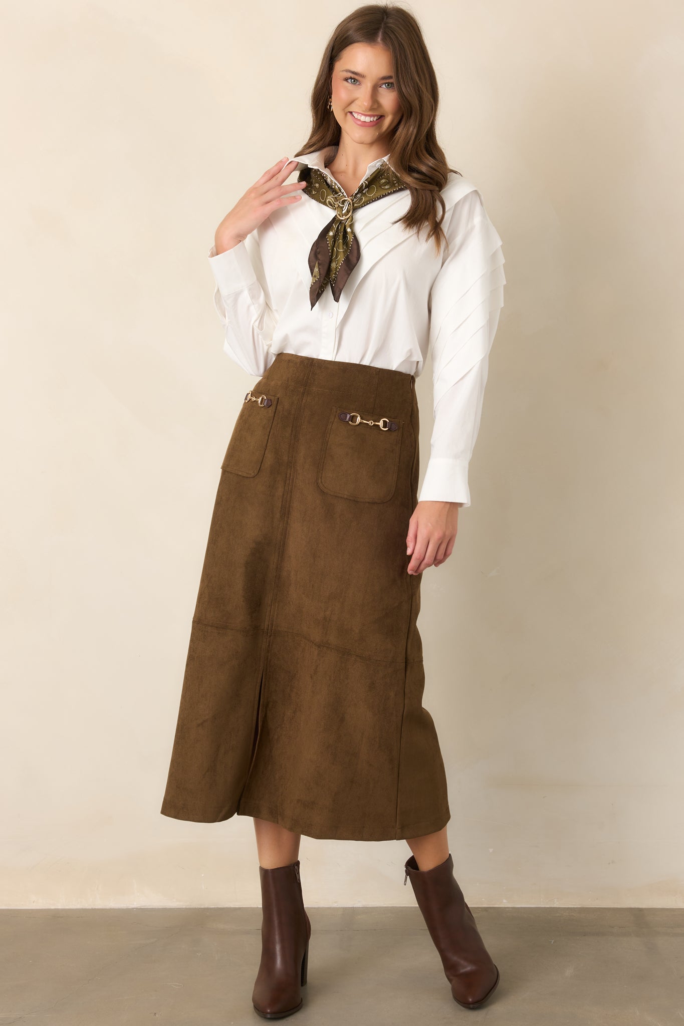 High-rise midi skirt with front patch pockets, gold-tone hardware, and a tailored silhouette with center-front slit.