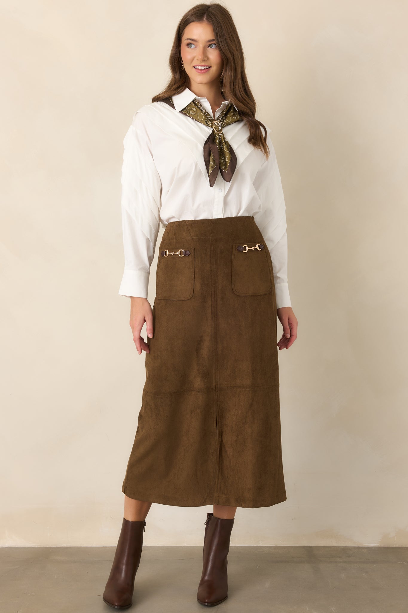 High-rise midi skirt showcasing a clean tailored shape, patch pockets, and a front slit.
