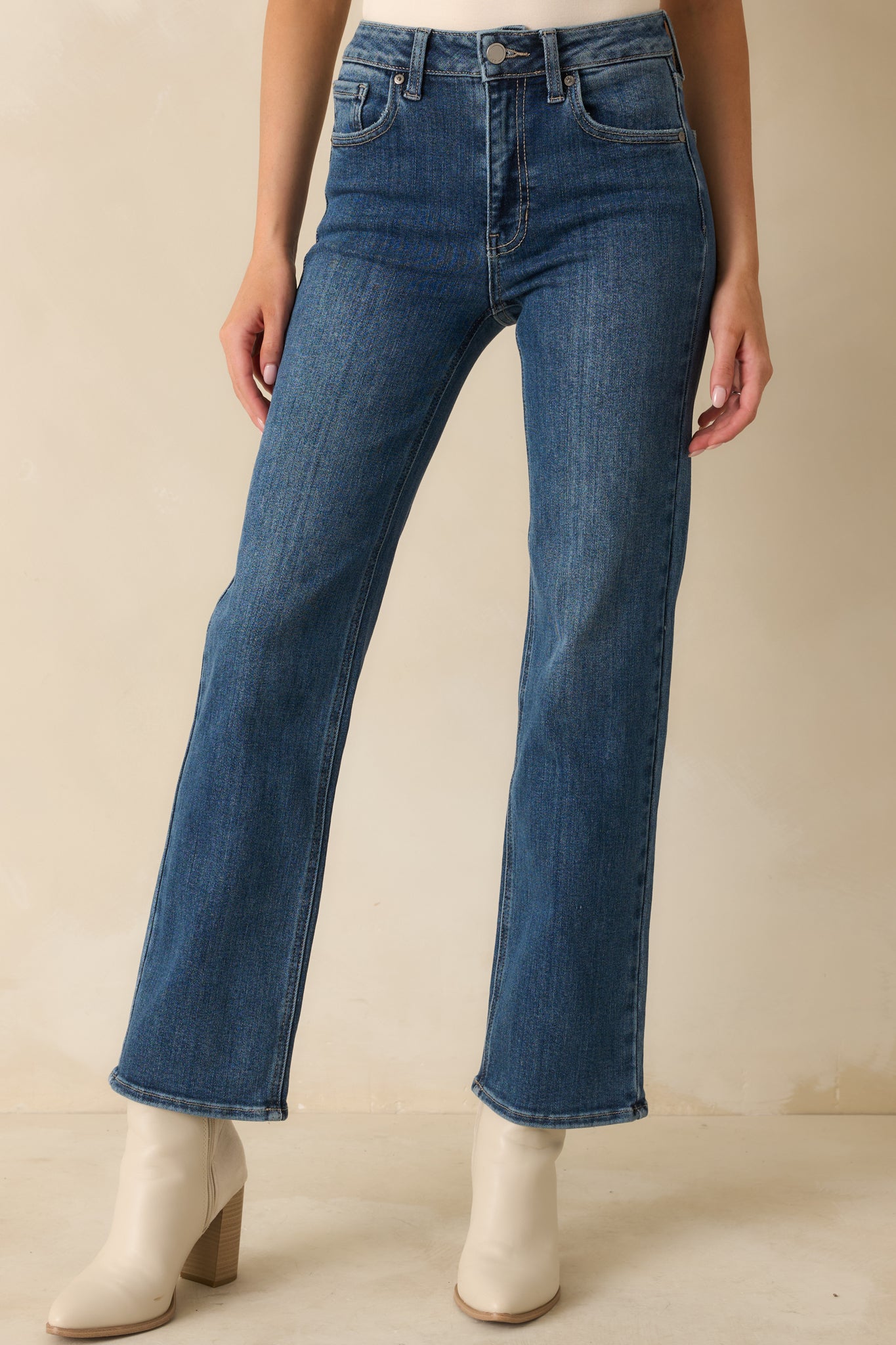 High-rise jeans cropped view highlighting straight-leg shape, clean front pockets, and soft worn-in wash.