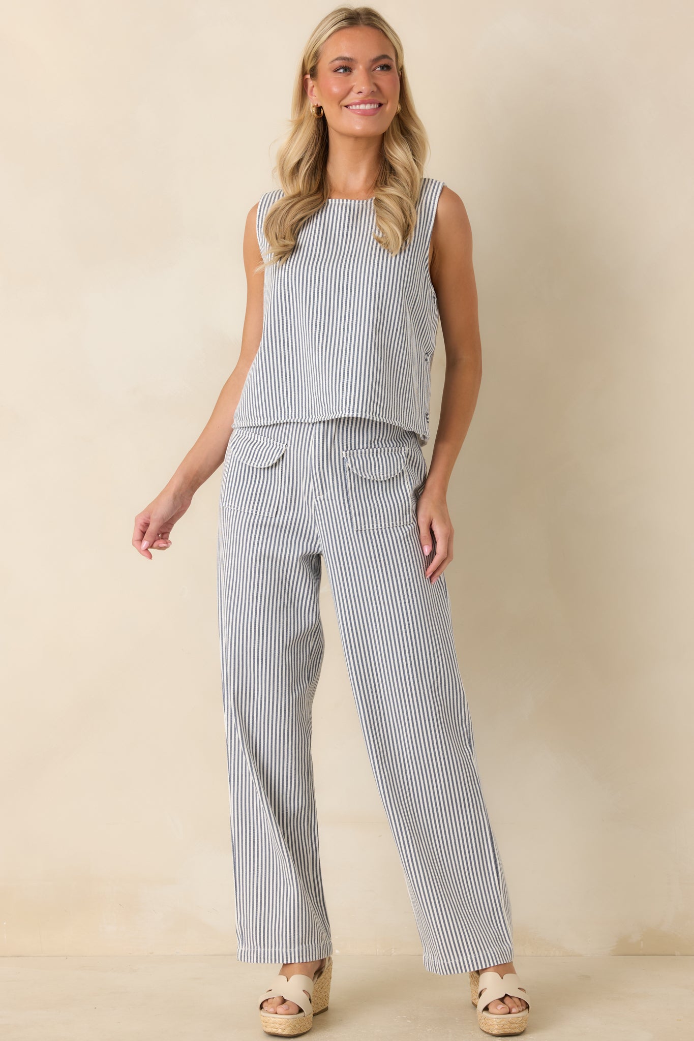 High-rise striped pants designed with a relaxed fit, wide legs, and functional belt loops.