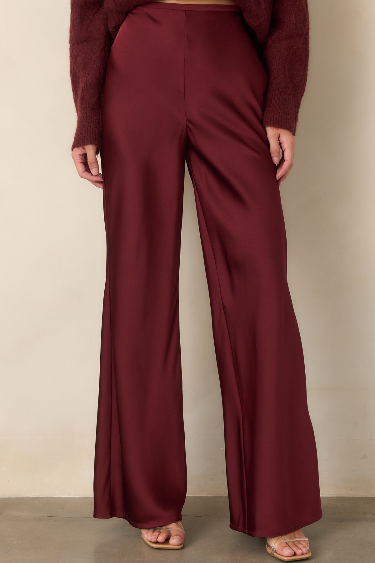 High-rise pants highlighting the structured flat-front waistband and softly flowing wide-leg shape.
